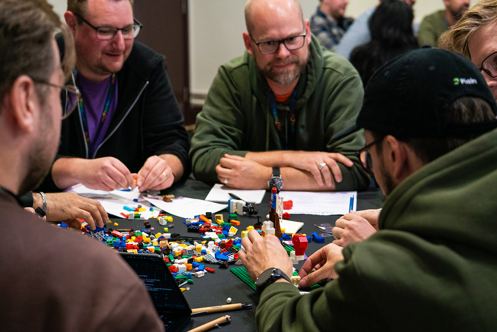 Quality people gathered and learning around a table with Lego