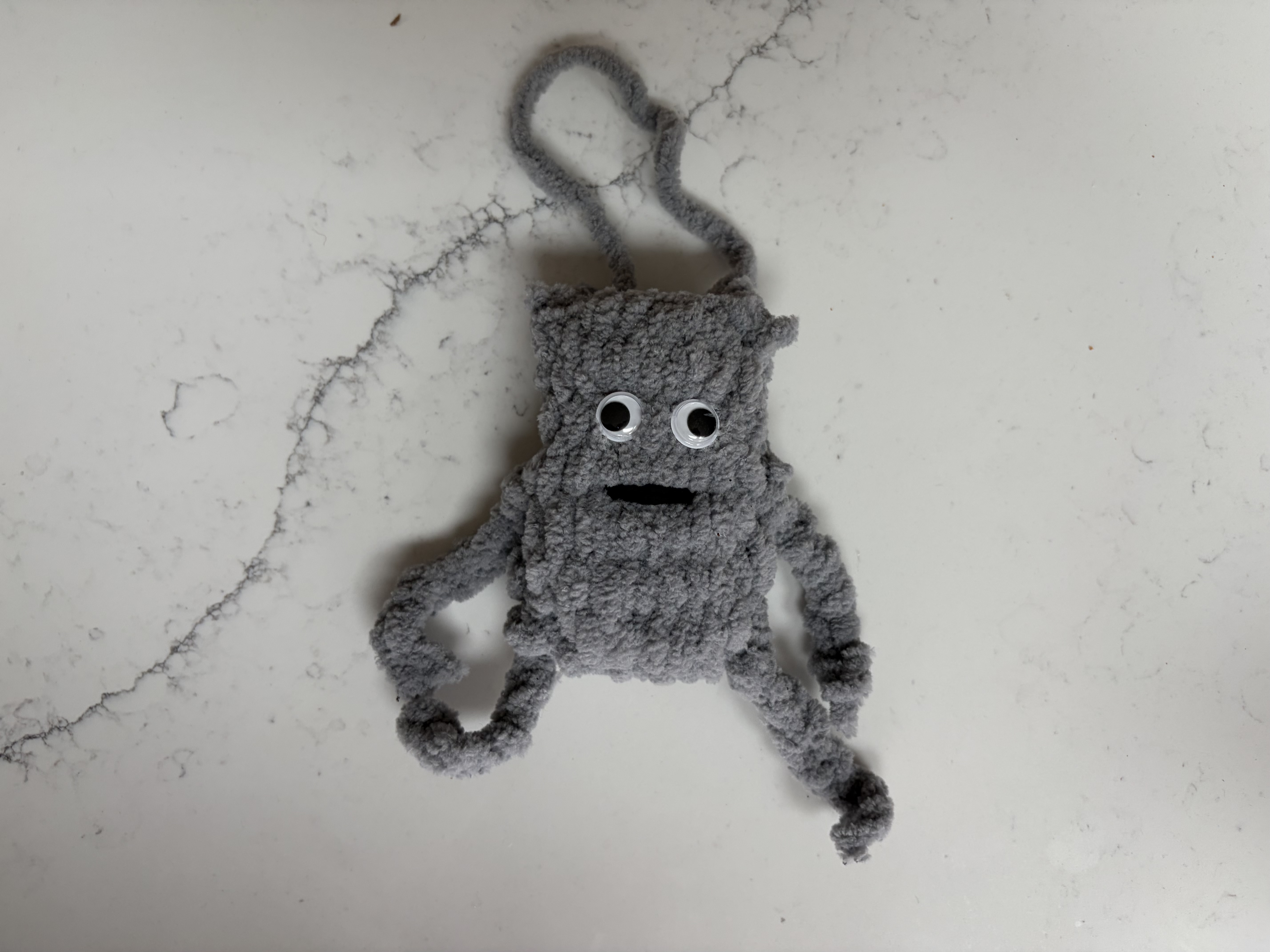 A hand crafted mini bug bag with google eyes image