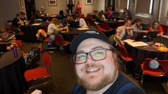 Selfie of Ben Dowen looking back at tables of attendees at the workshop image