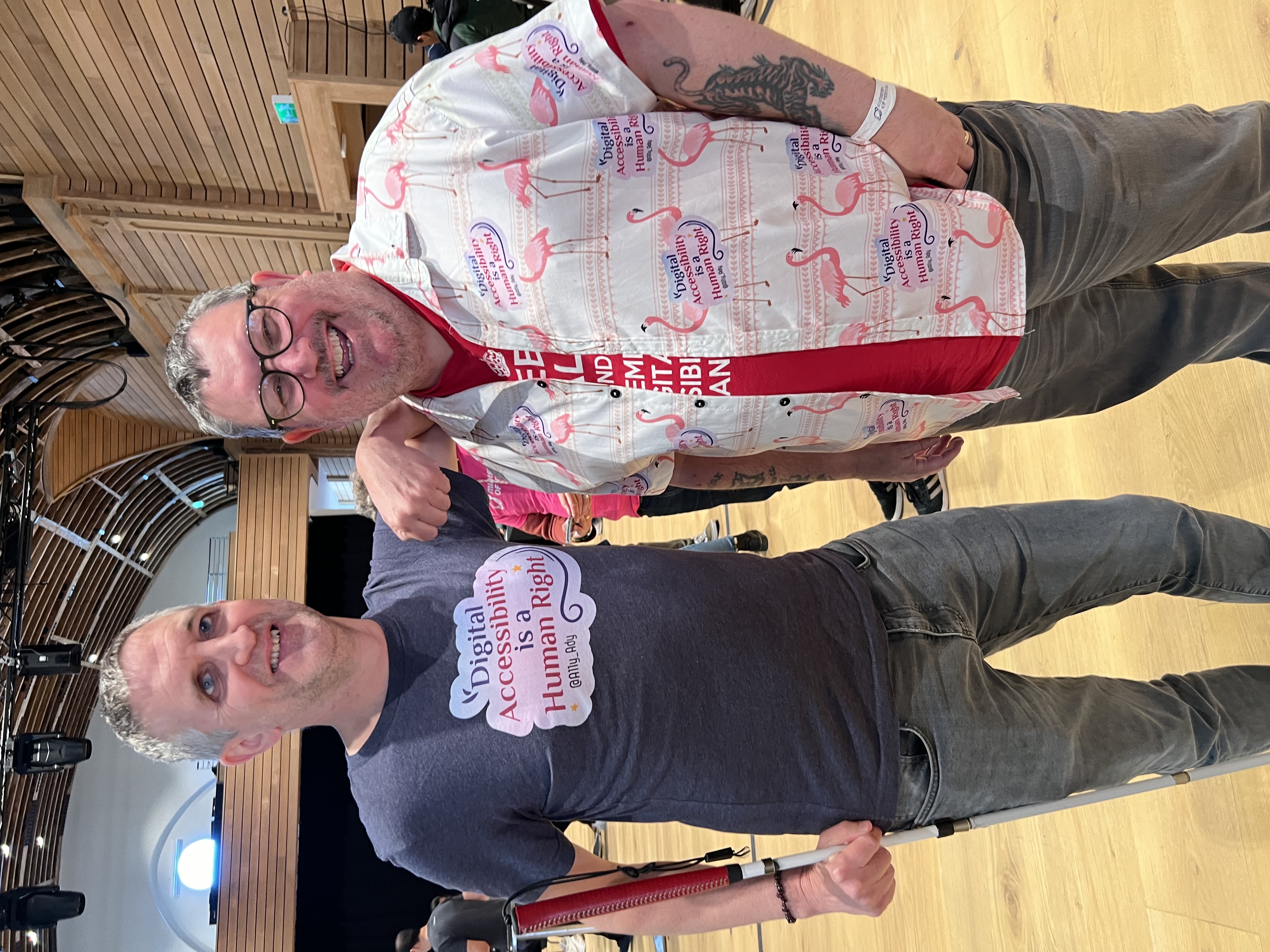 Conor and I with him wearing a t-shirt with my accessibility is a human right graphic while I’m wearing my Hawaiian shirt with the same graphic on it. 