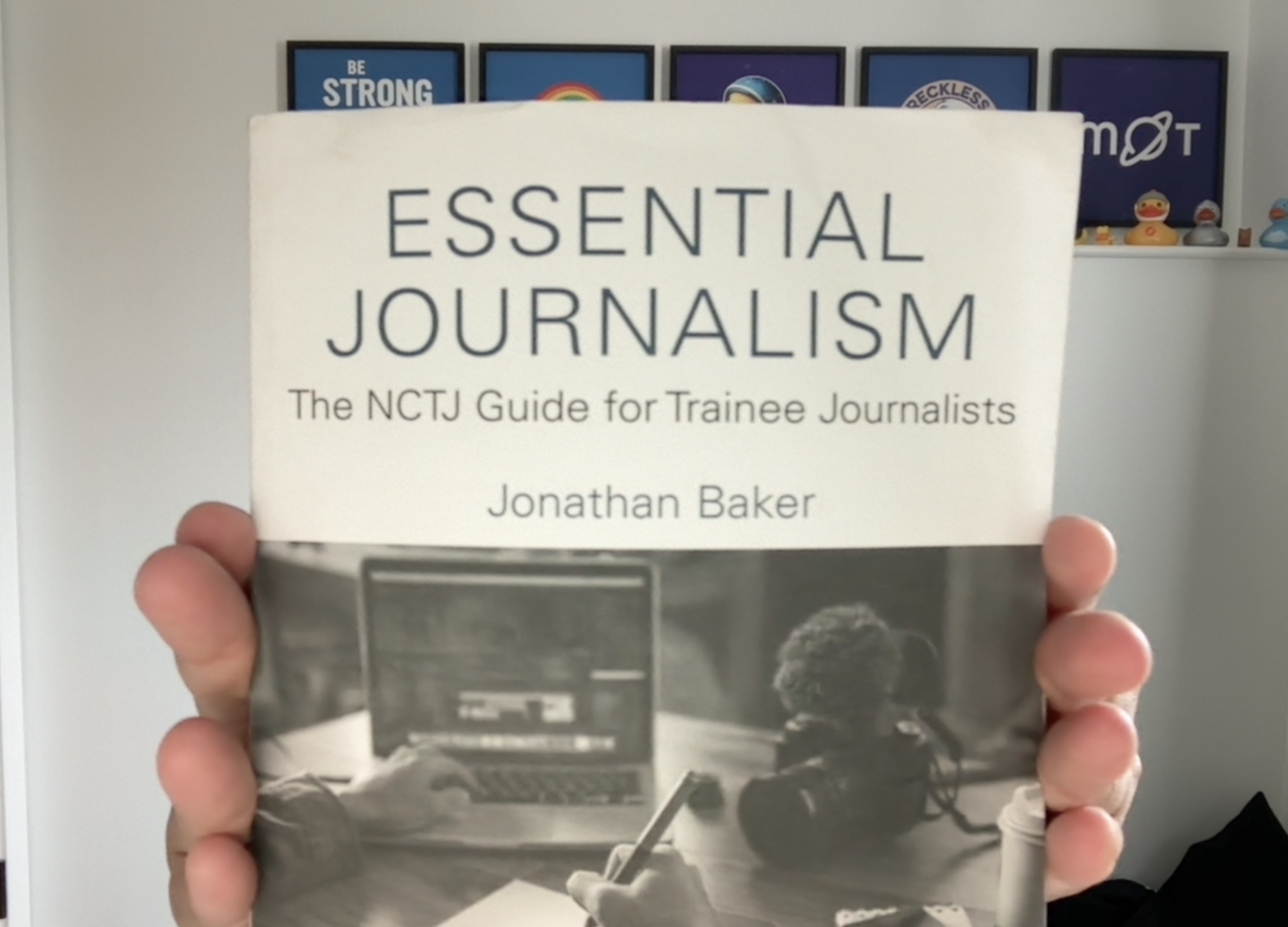 This photo is of me holding a book of Essential Journalism, the NCTJ guide for trainer journalists. By Jonathan Baker. image
