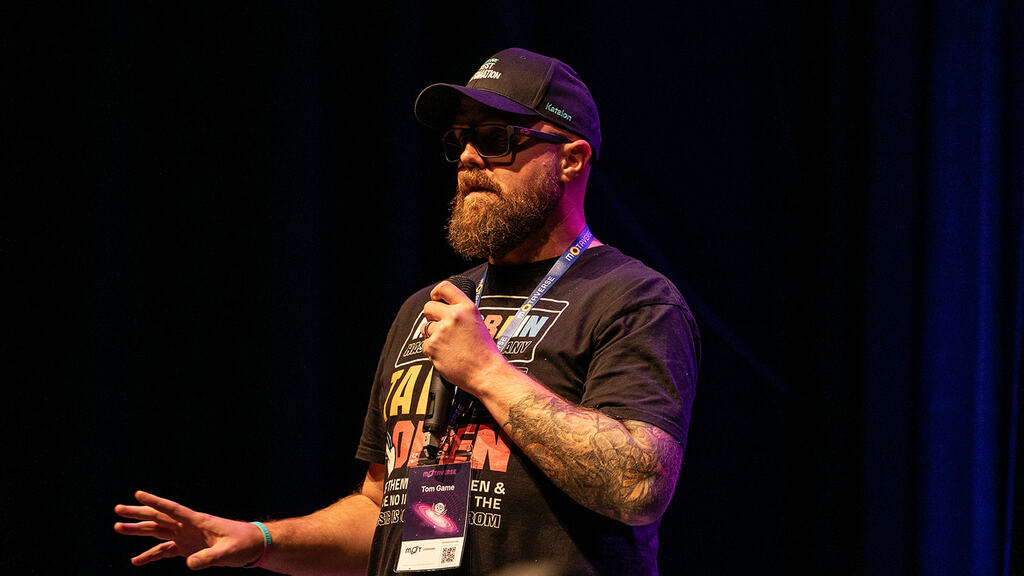 Tom Game taking to the 99 second talk challenge image