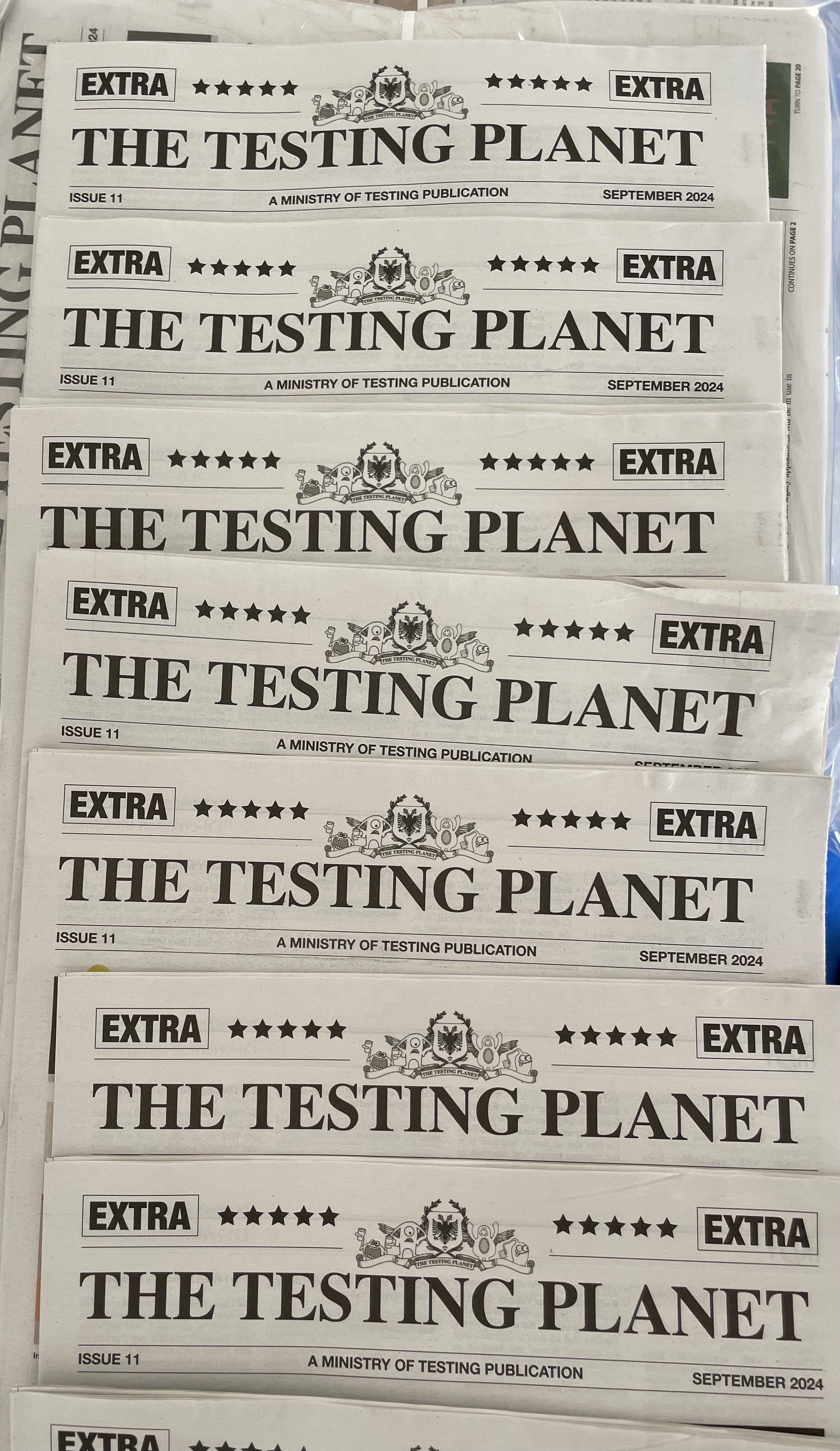 A row of printed The Testing Planet newspapers.