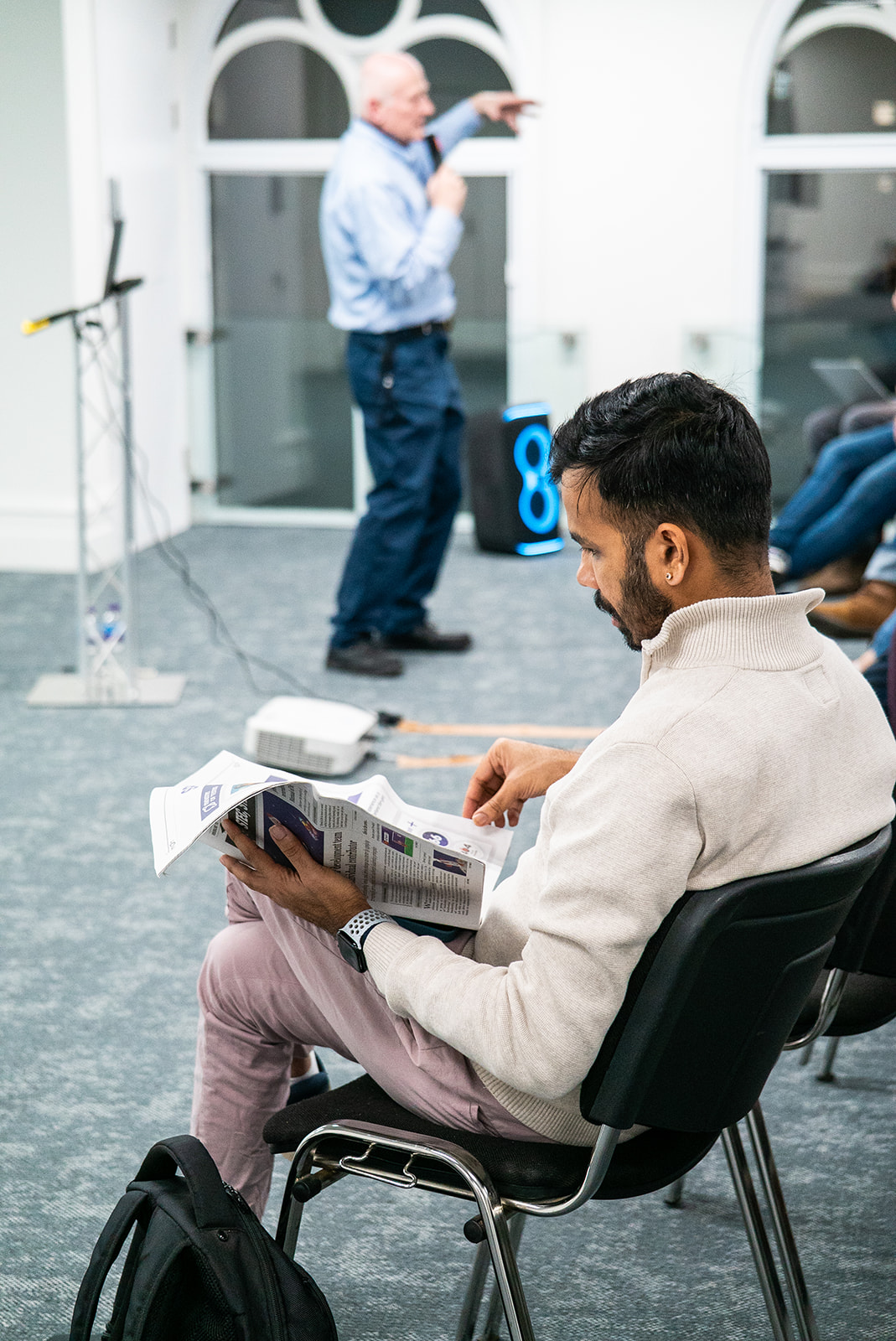 An attendee reading The Testing Planet.