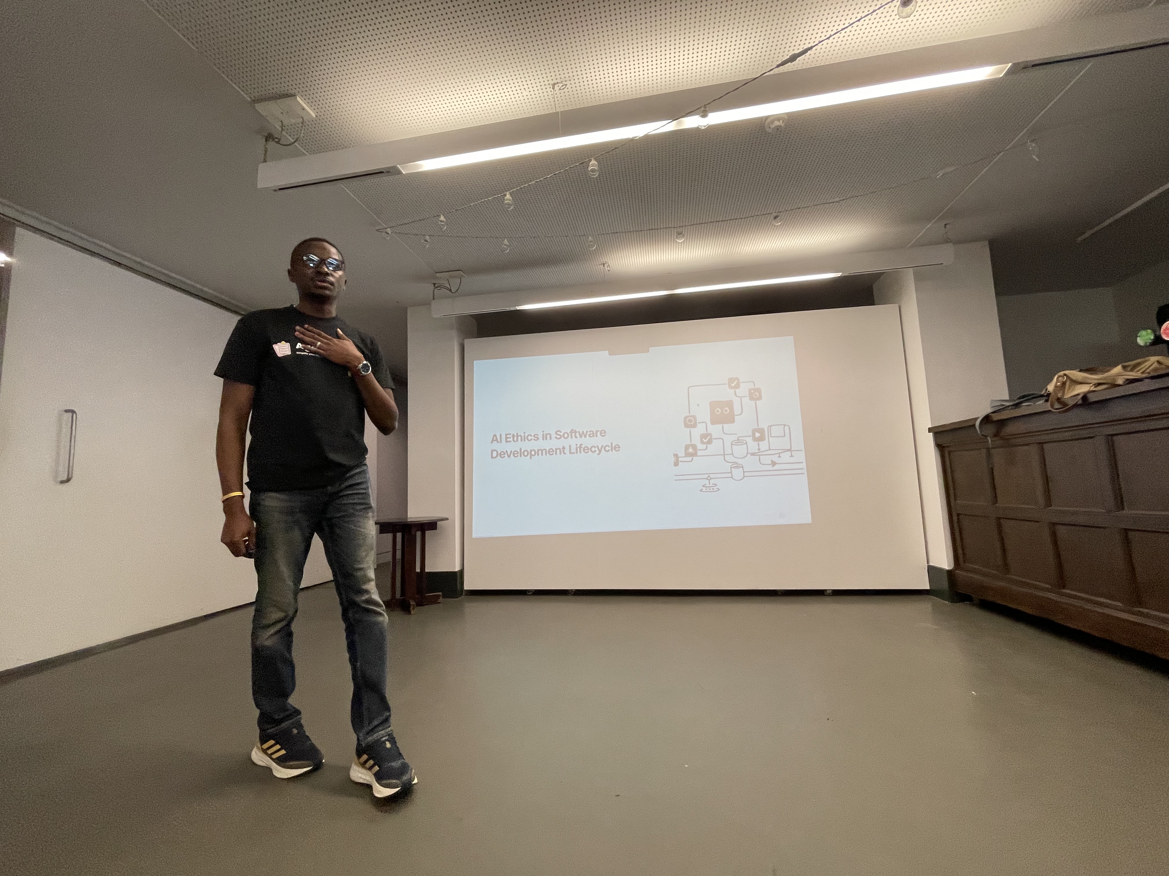A photo of Olawale Ibitoye on stage talking about AI ethics.