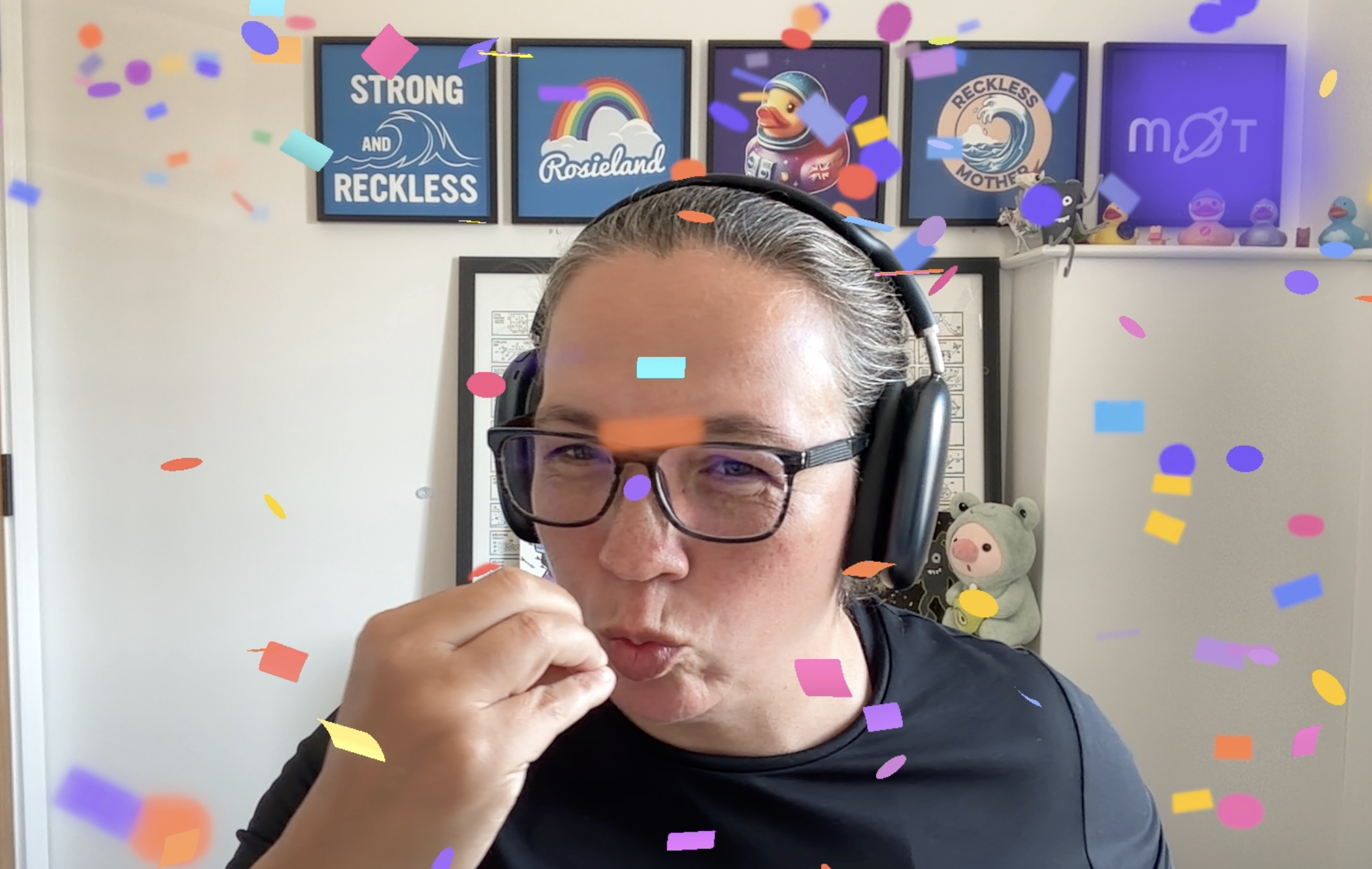Rosie is reenacting a chef's kiss with digital confetti dropping down around her image