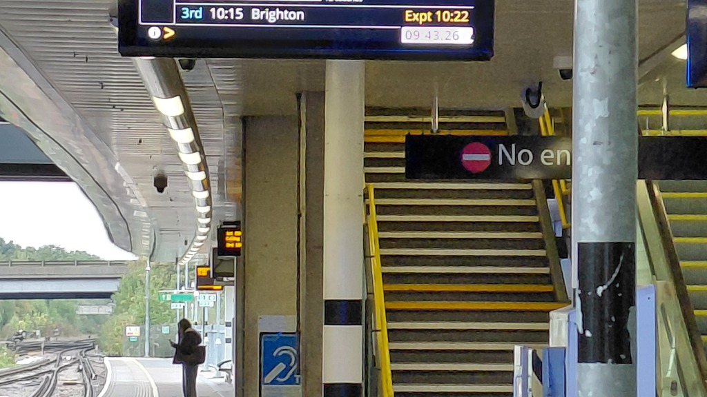 Information board at the Gatwick trainstation showing information about the train to Brighton. image