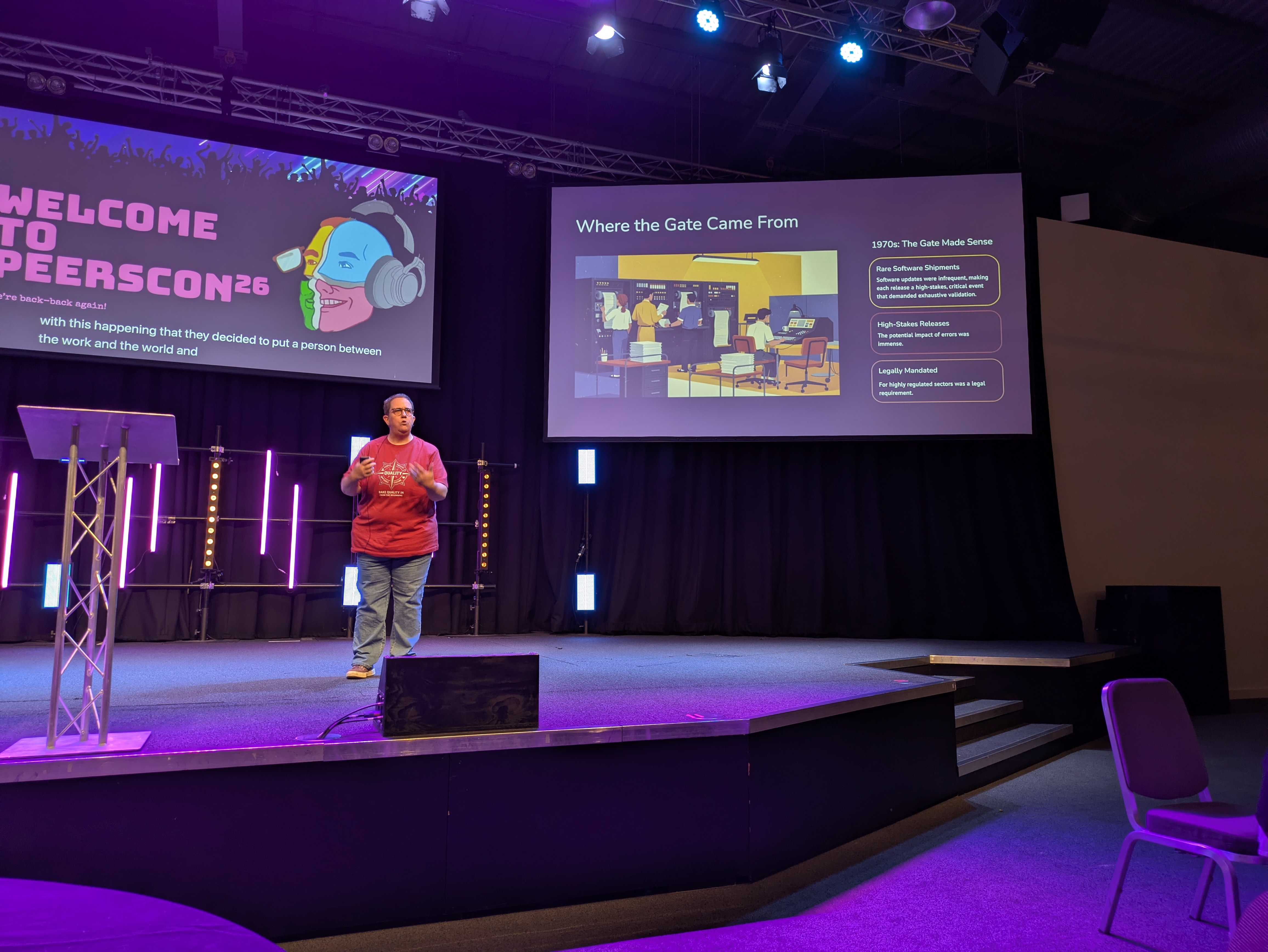 A photo of Phillipa Jennings on a stage at PeersCon doing a talk.