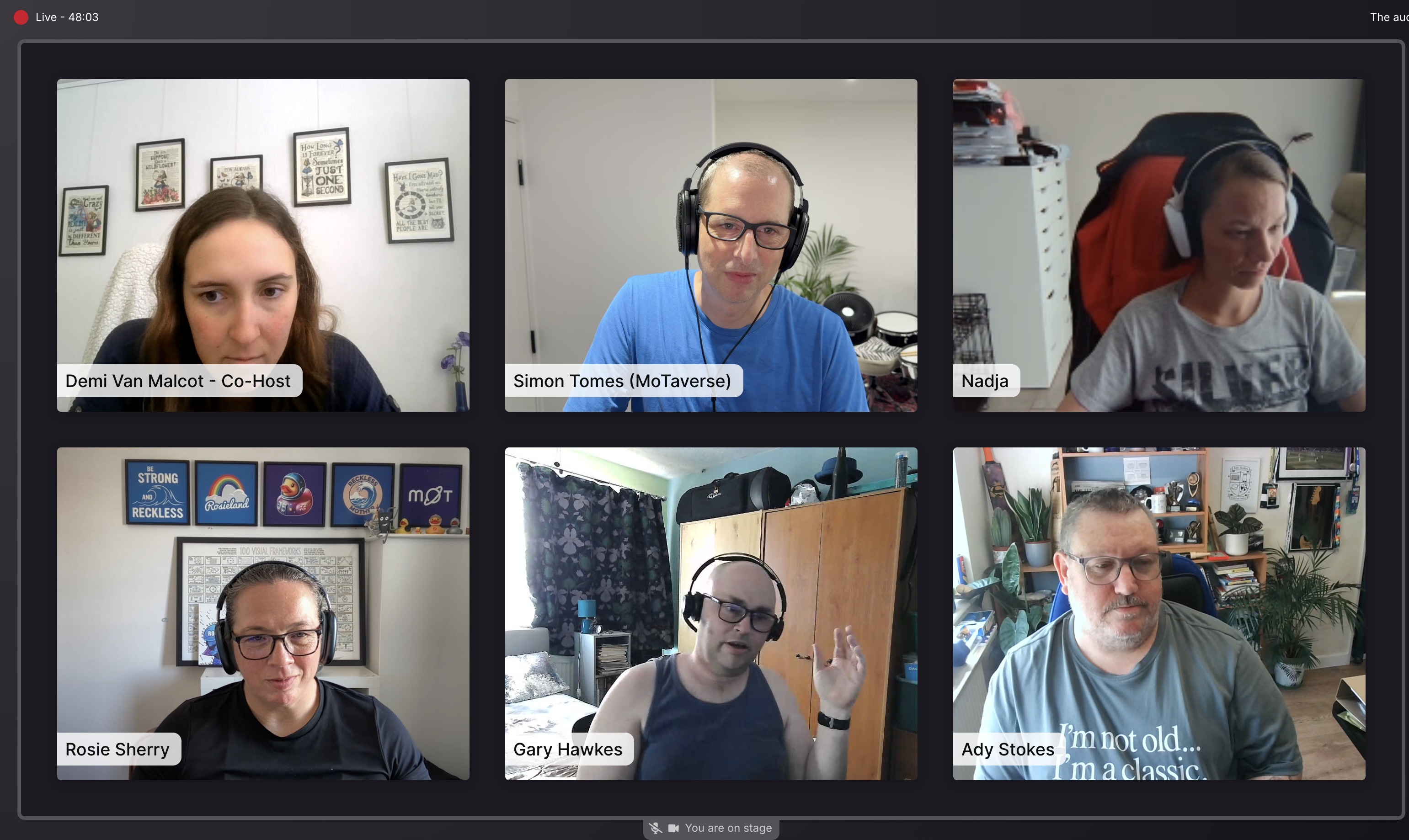 Screenshot of a 6-person live video conference grid on a dark interface. Top row, left to right: Demi Van Malcot - Co... image
