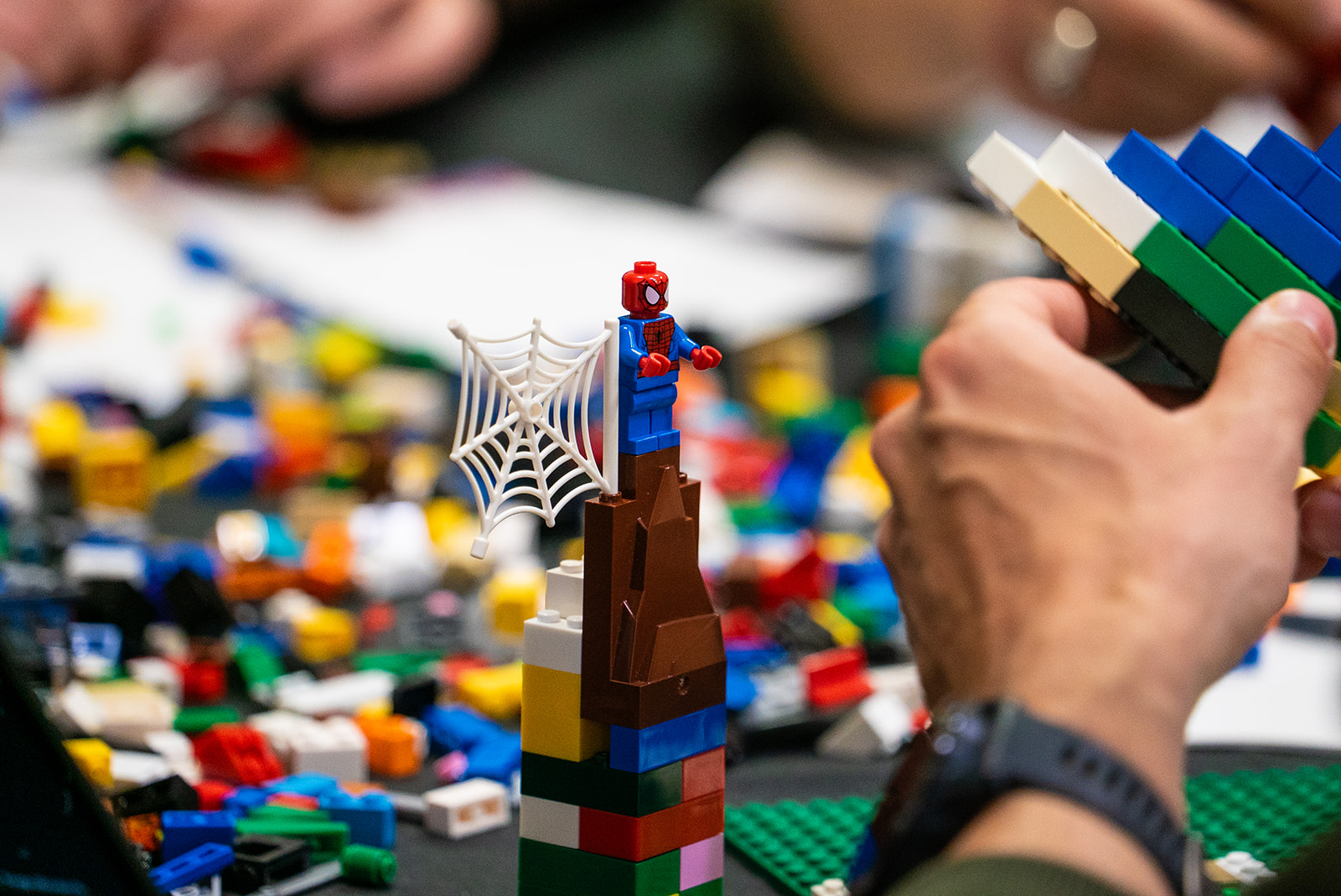 Lego with Spiderman holding a web.