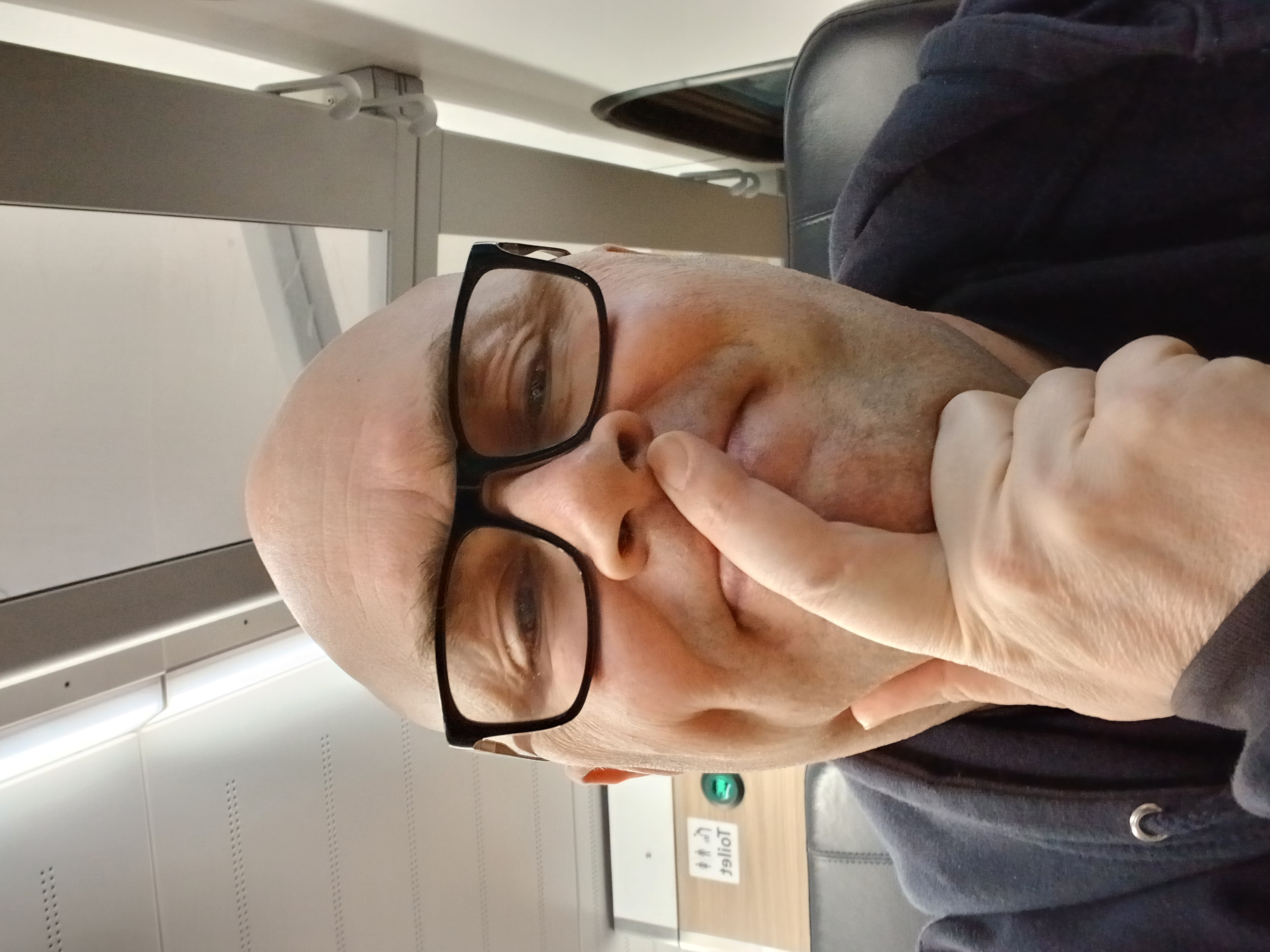 Selfie of a man sitting on a train