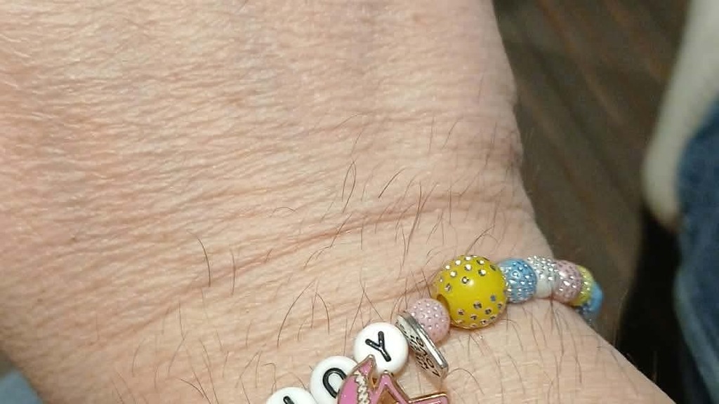 Picture of a bracelet made by Clare Norman made with beads and the word Joy in the centre image