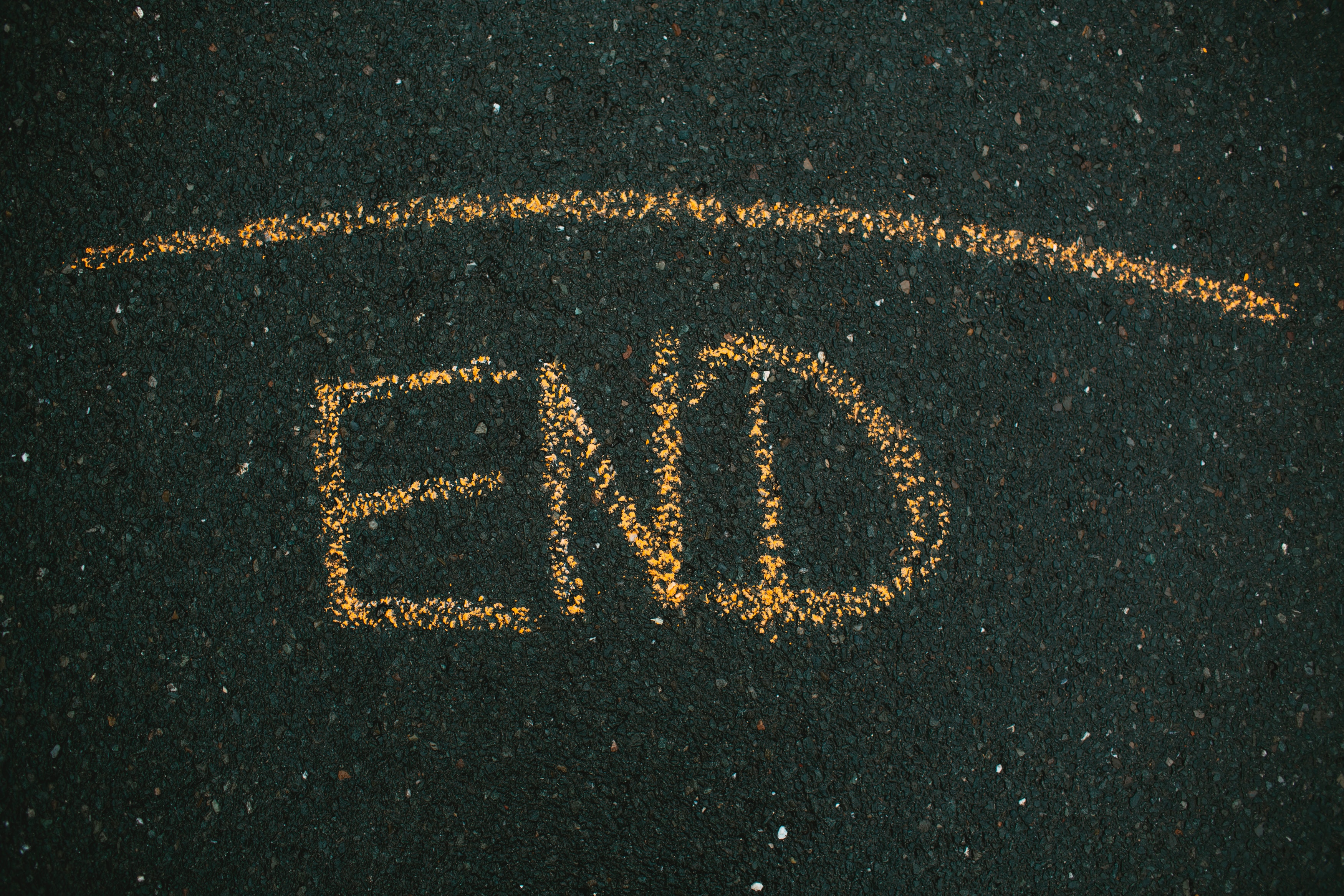 A picture of tarmac with the word End written on the road