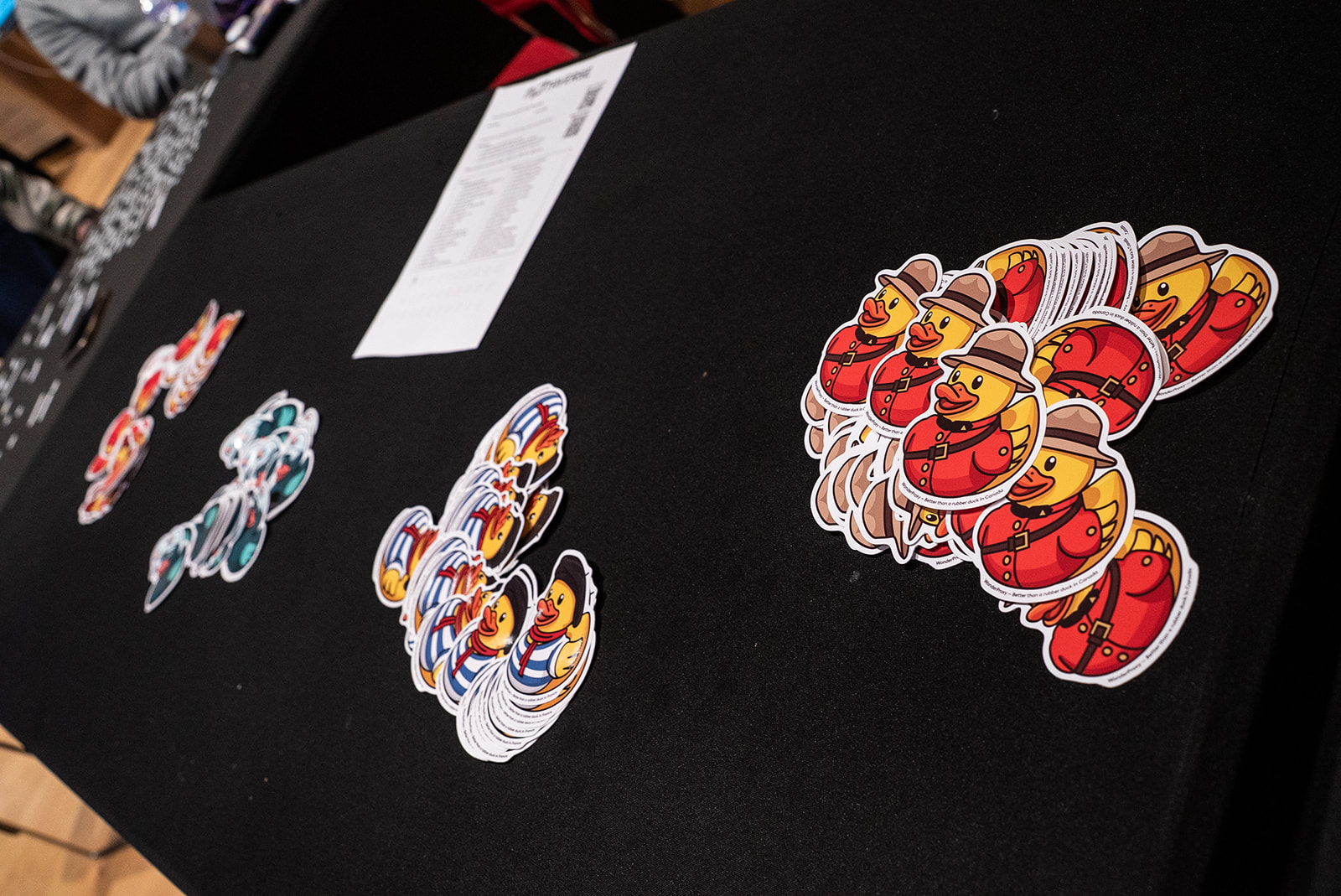 A photo of duck stickers on a black table.