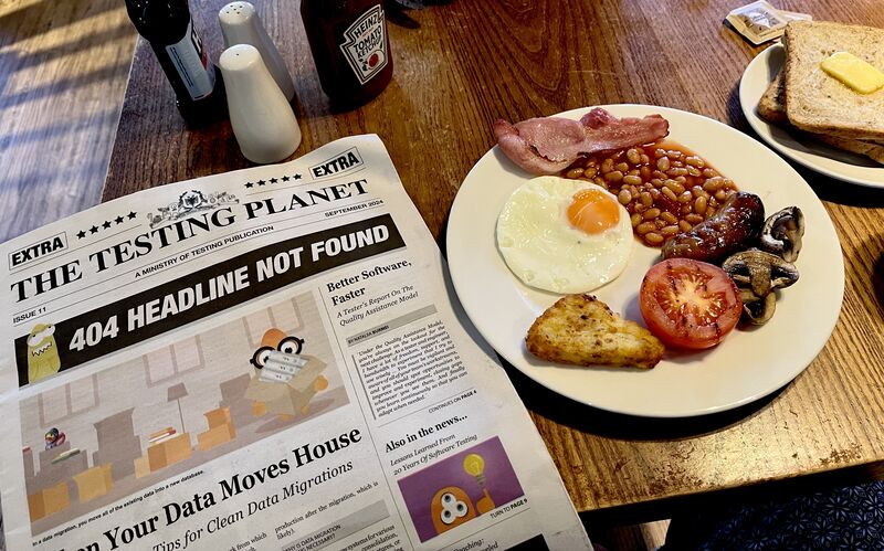 A table with Full English Breakfast and eleventh Issue of The Testing Planet.