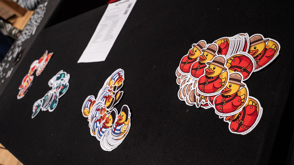 A photo of duck stickers on a black table.