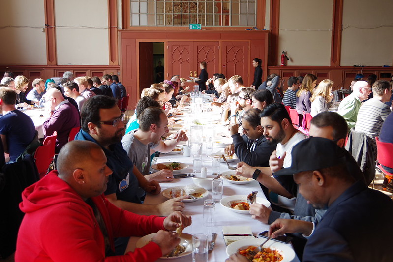 People eating and long food tables at TestBash 2016 image
