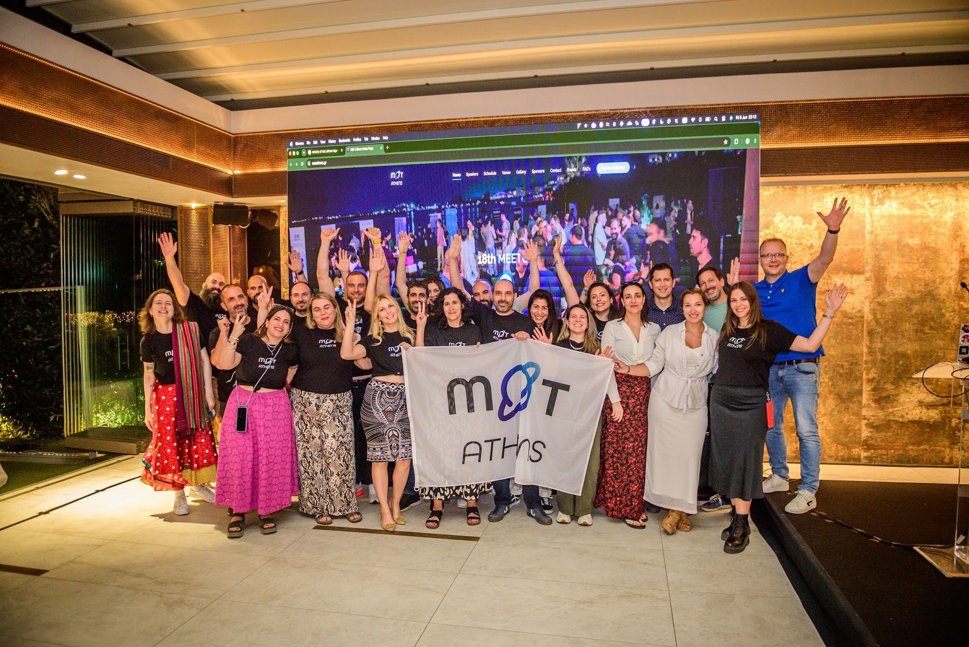 "A group from the Ministry of Testing Athens team on stage together with the speakers image