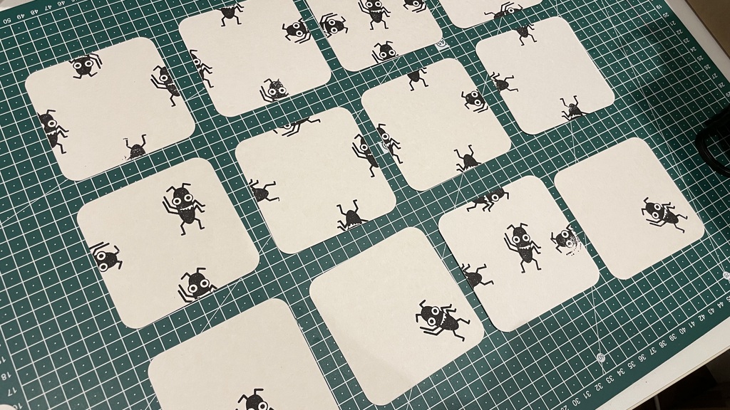 A photo of coasters with Bug stamped on them in many different creative ways.