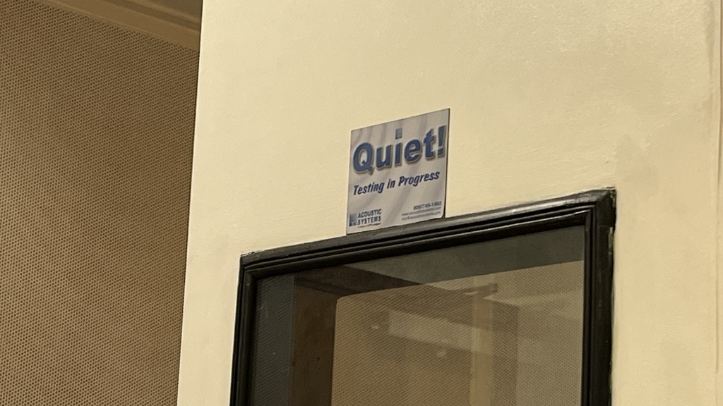 Signage reading "Quiet! Testing in Progress" image