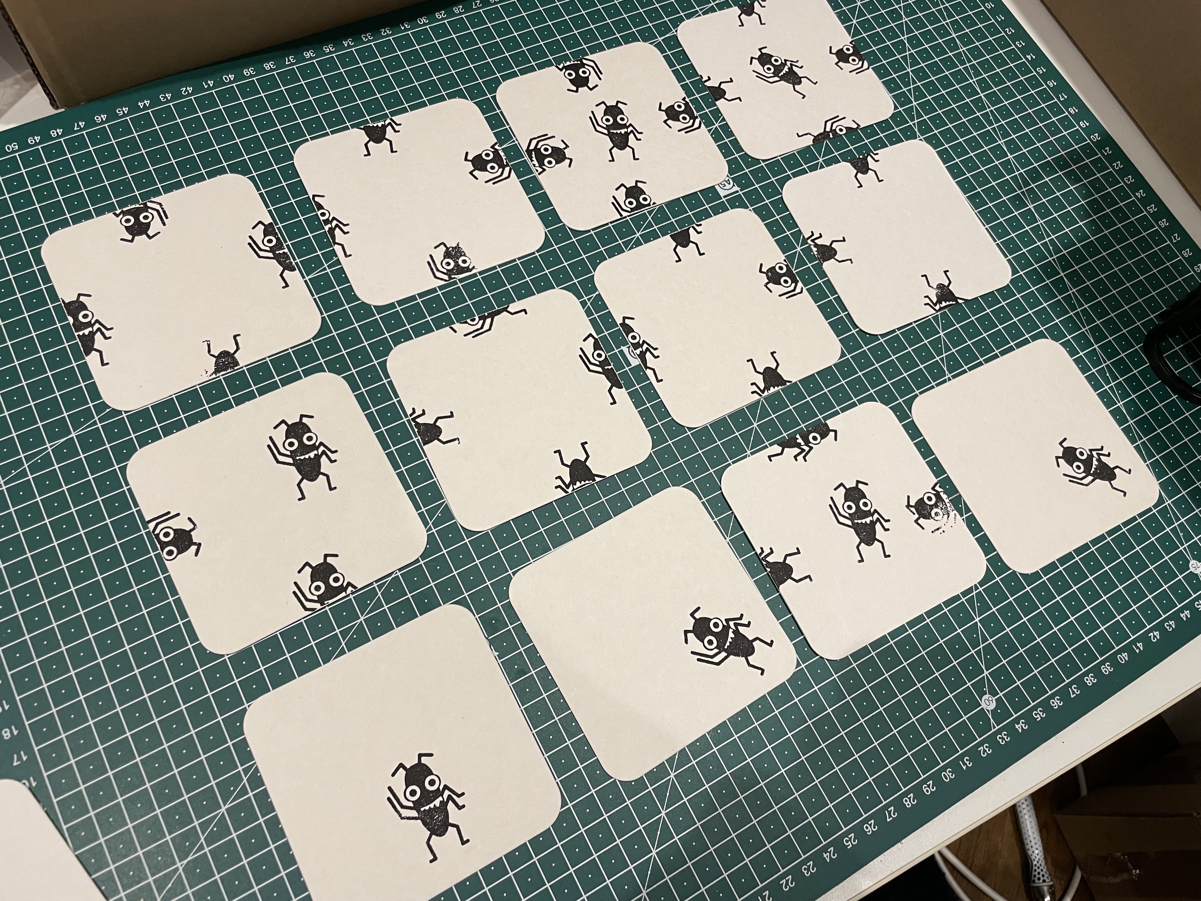 A photo of coasters with Bug stamped on them in many different creative ways.