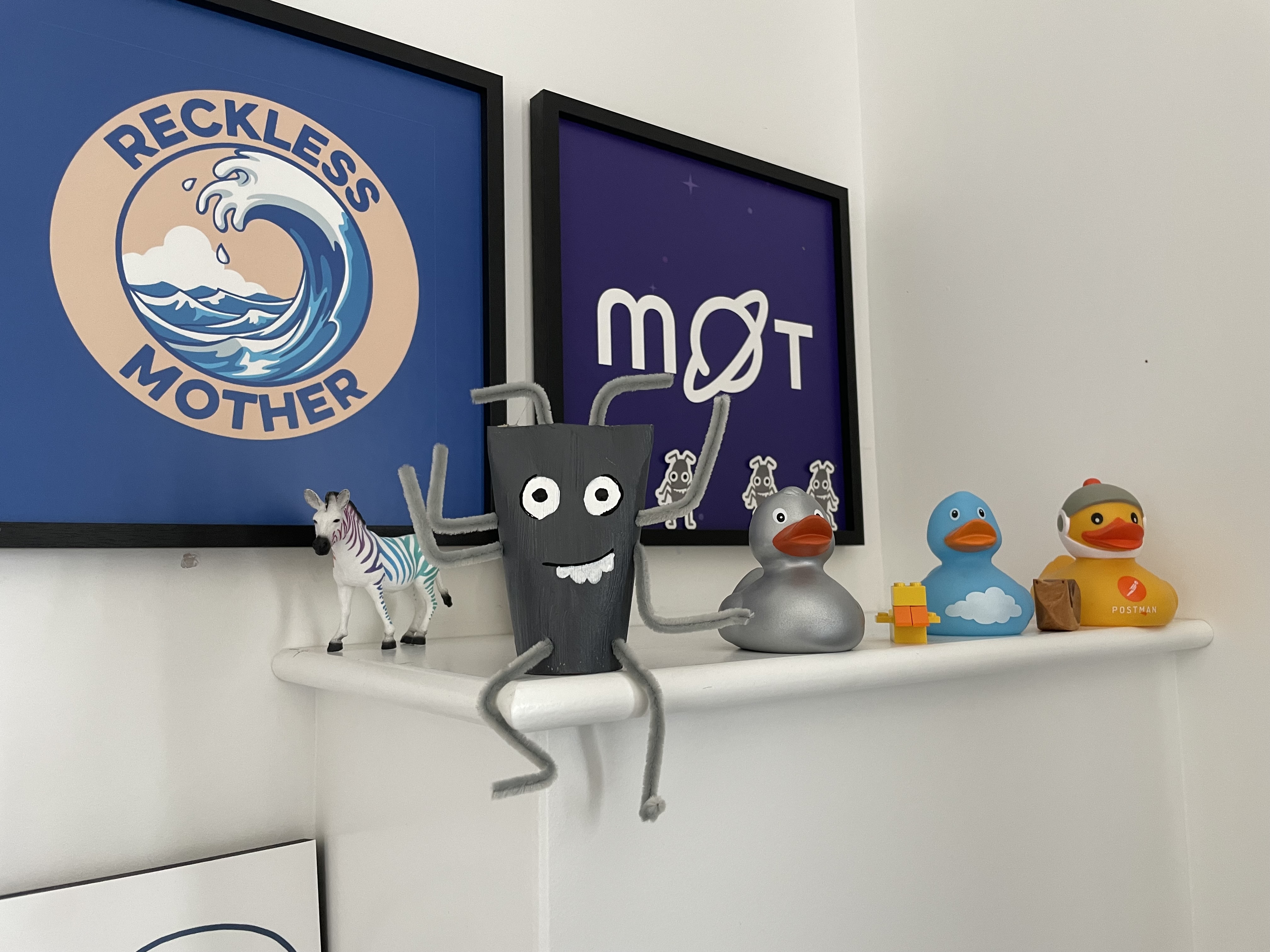 A toilet roll bug sitting on a wall along side ducks, a rainbow zebra, reckless mother picture and mot picture.