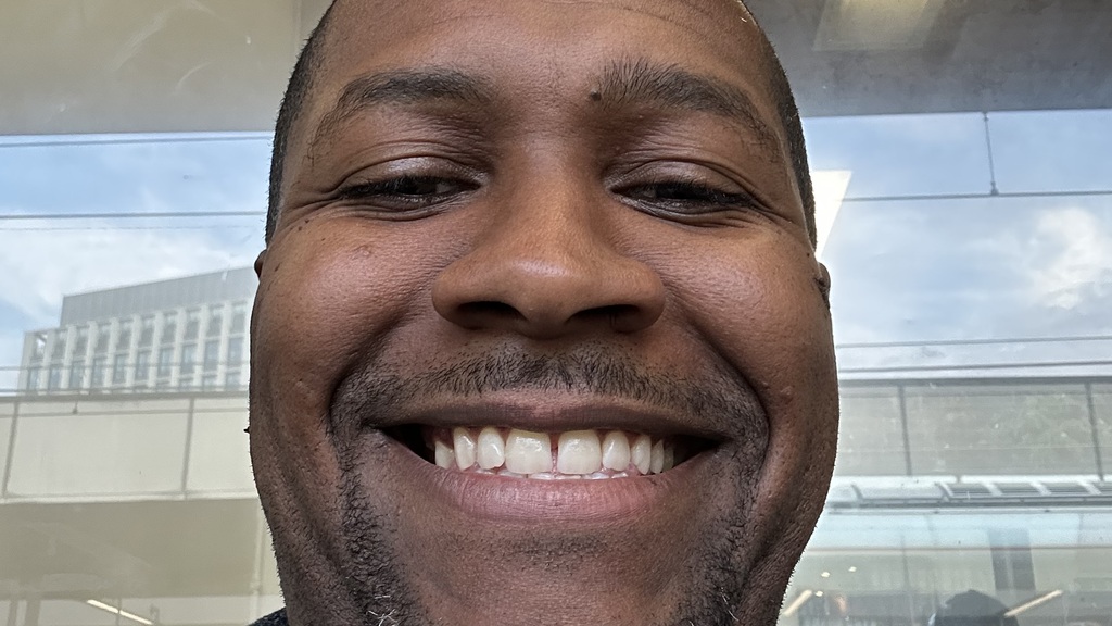 A man smiling in a selfie image