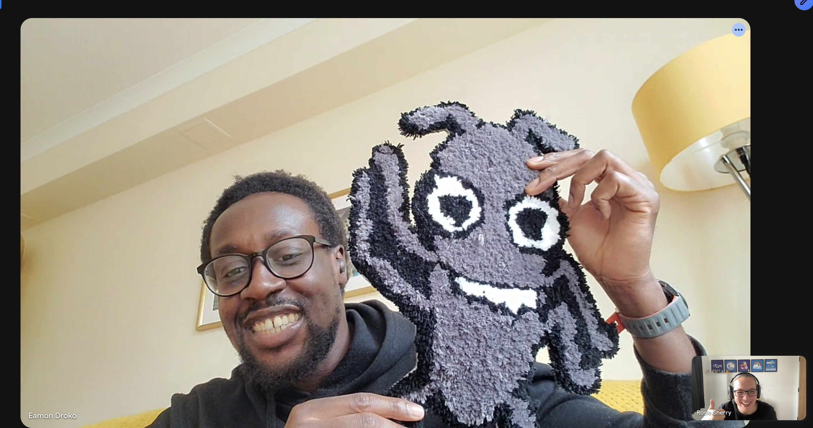 A screenshot of a virtual conversation with Eamon holding up Bug Rug.