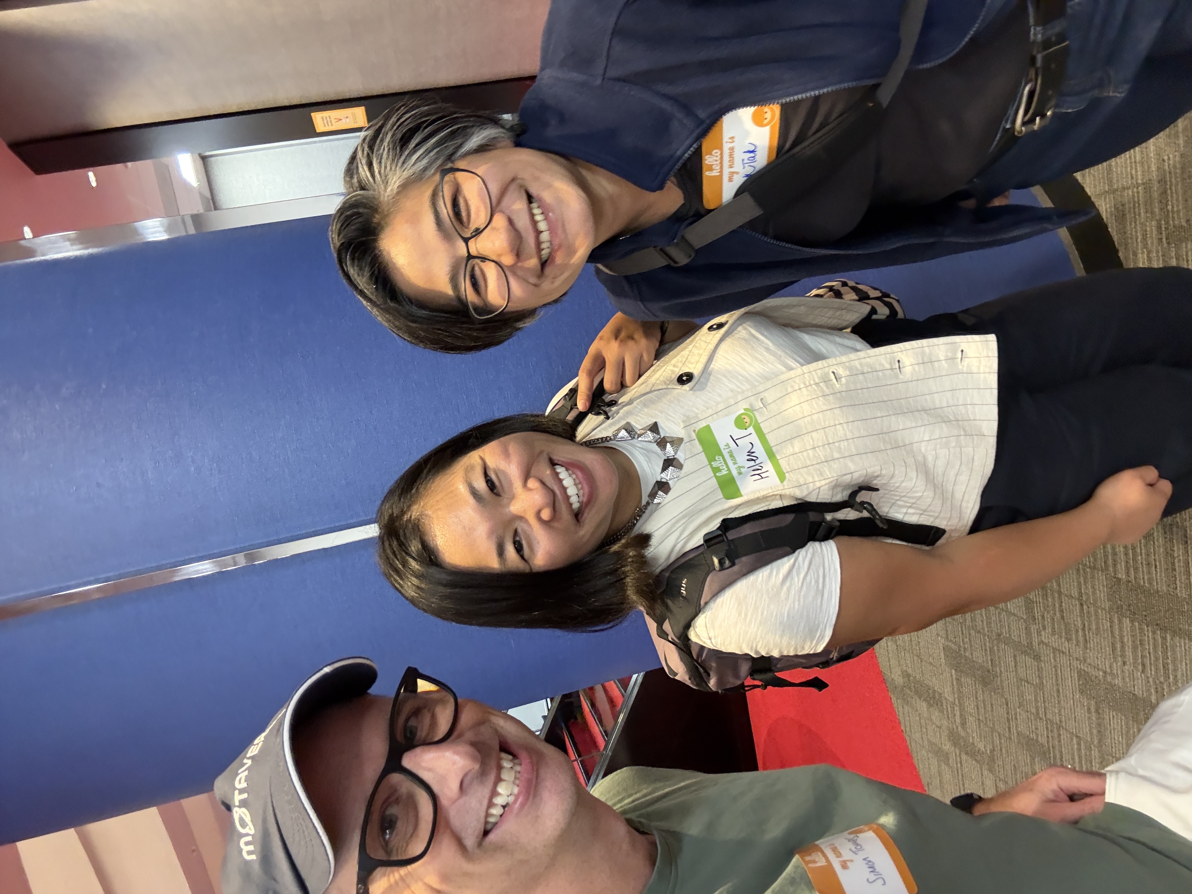 Three people pose for a selfie in an office event space. image