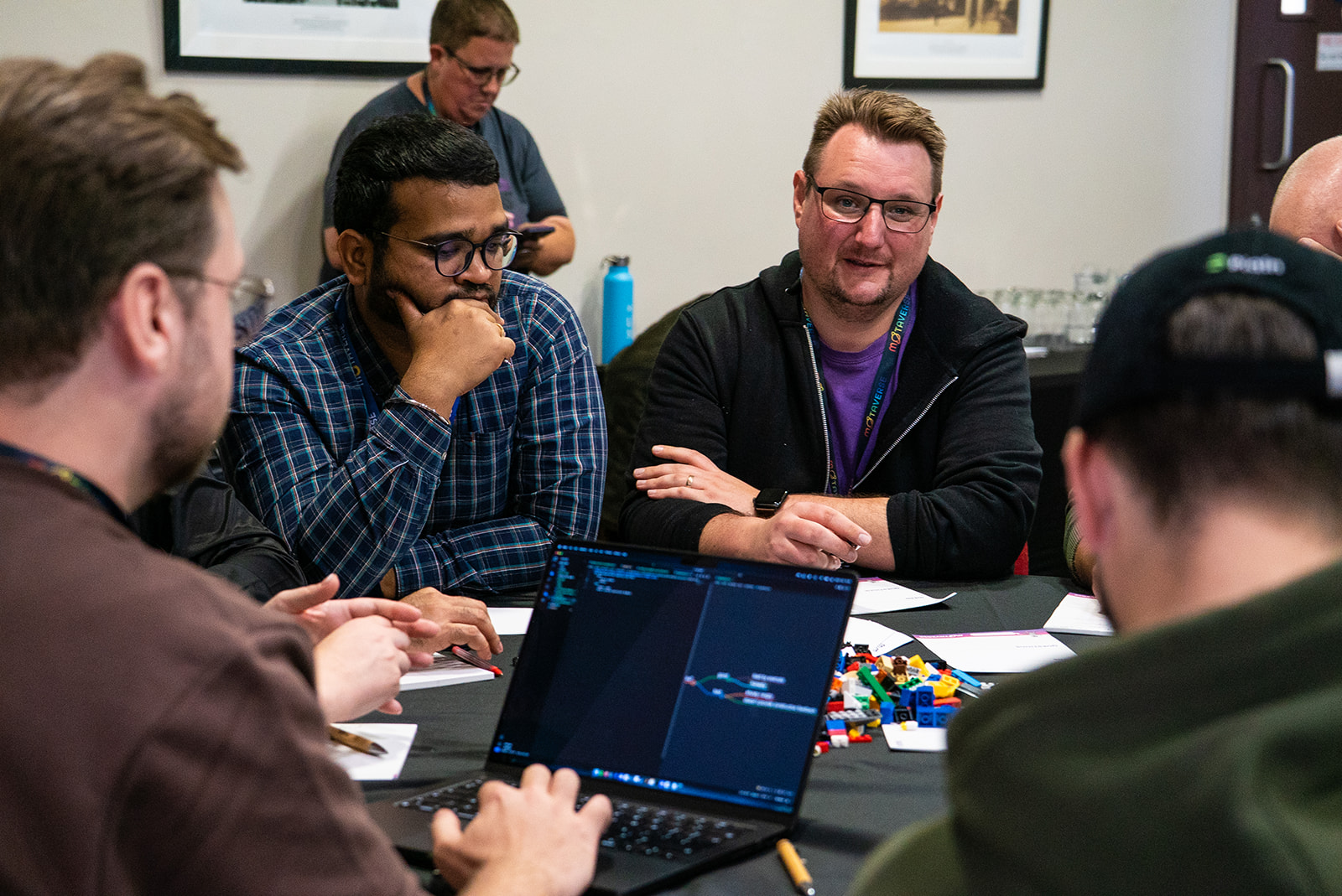 Quality people sitting around a table learning