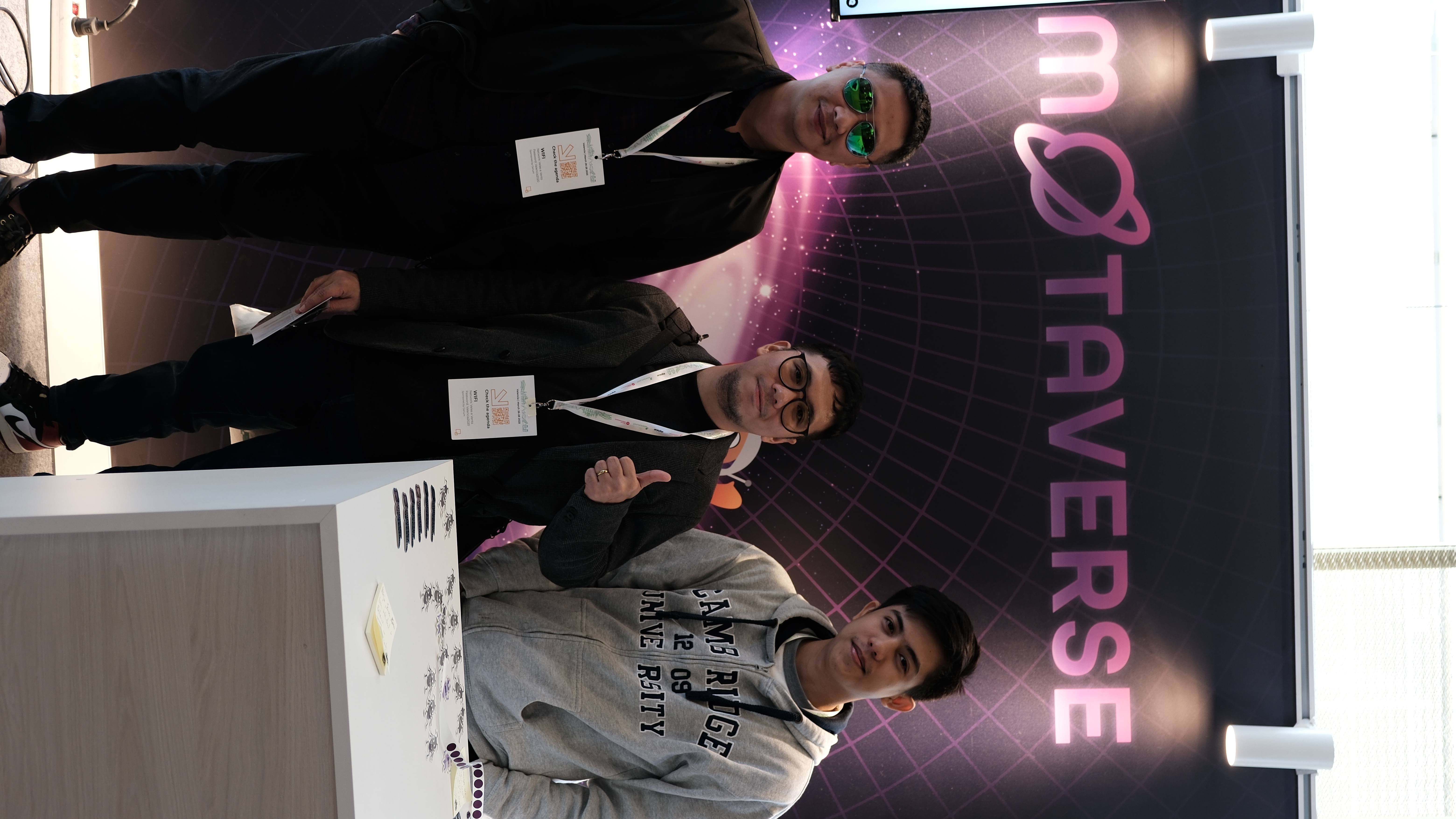 Three young software testers from the Philippines pose proudly at the Motaverse booth during Selenium Conf 2025, one of whom spoke on the closing panel of the conference.