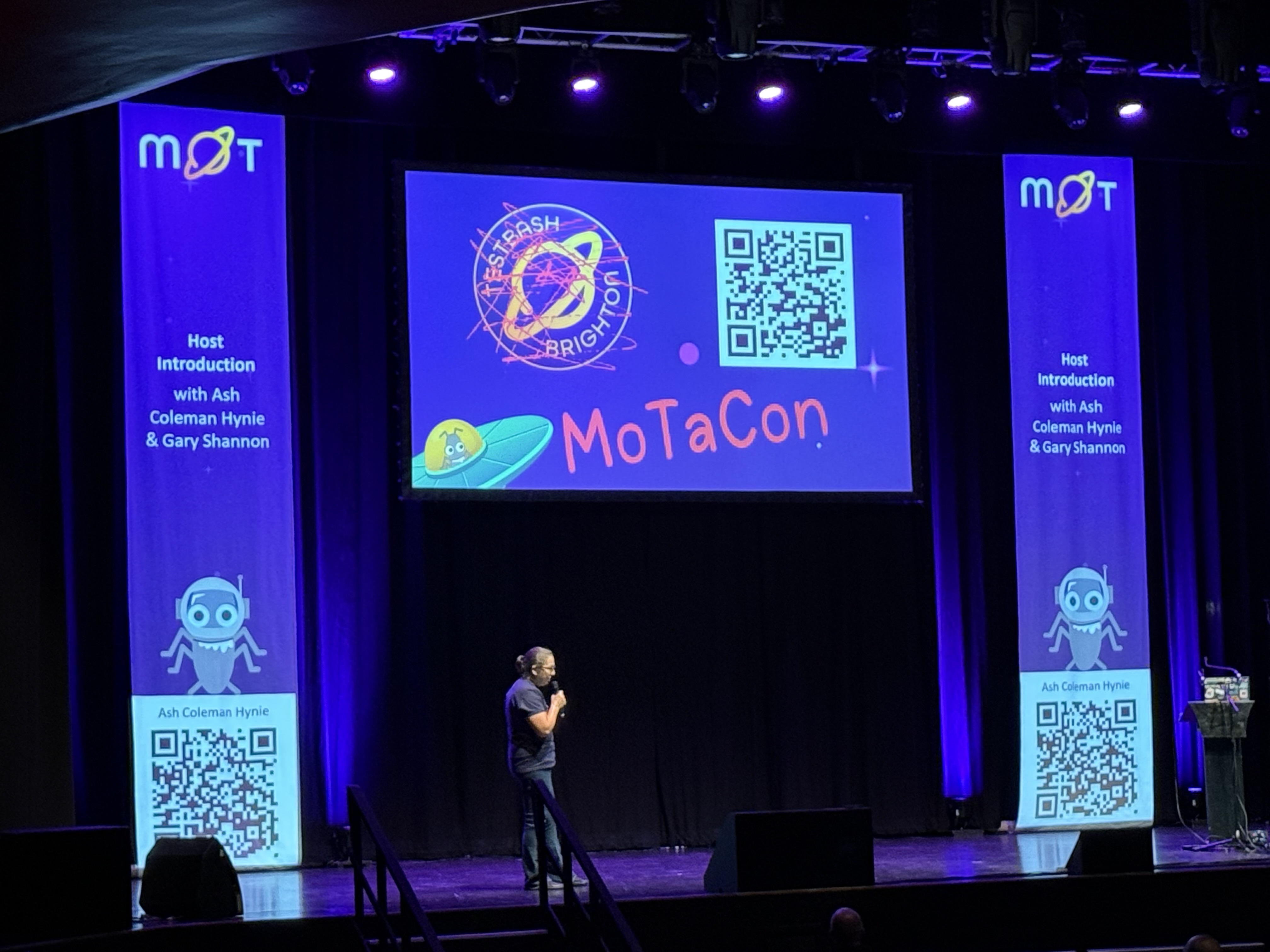 Rosie on stage announcing TeatBash will be MoTaCon moving forward. 