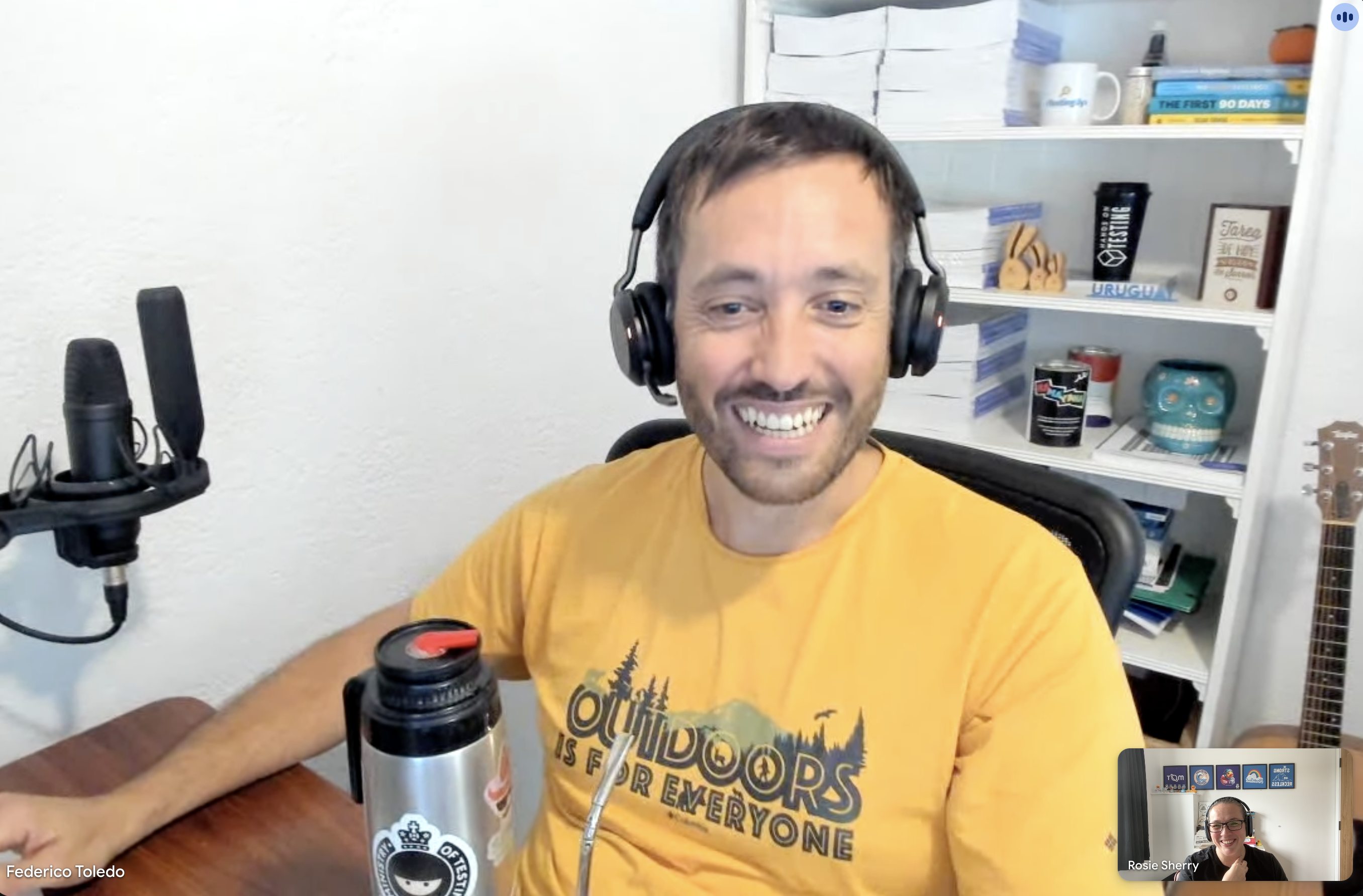 A screenshot of a virtual coffee catch up with Federico, he's looking happy with his waterbottle that Rosie is happy to see a retro MoT logo sticker on it.