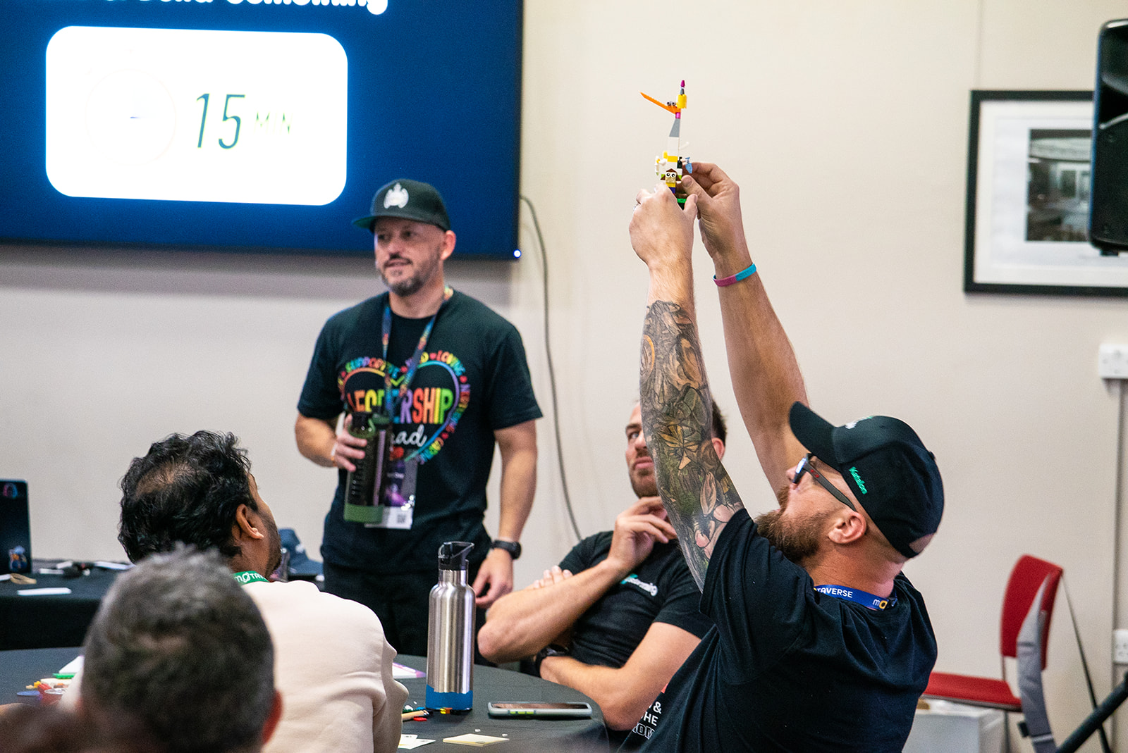 Tom Game holds lego up high with both his hands, a bit like the Lion King.