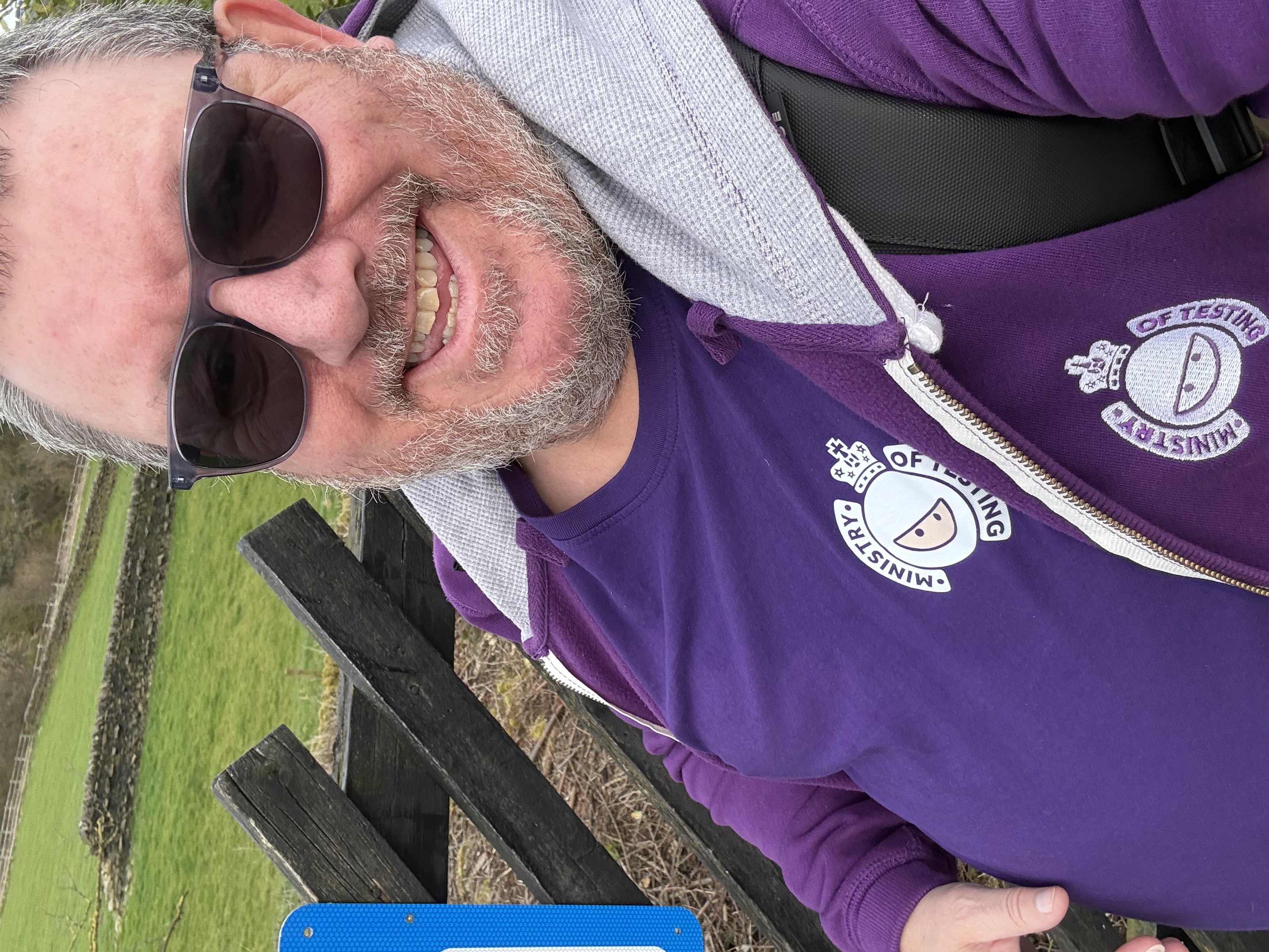 Ady, male with a short beard and haircut with gray hair, is on the platform in sunglasses purple retro T-shirt and ho... image