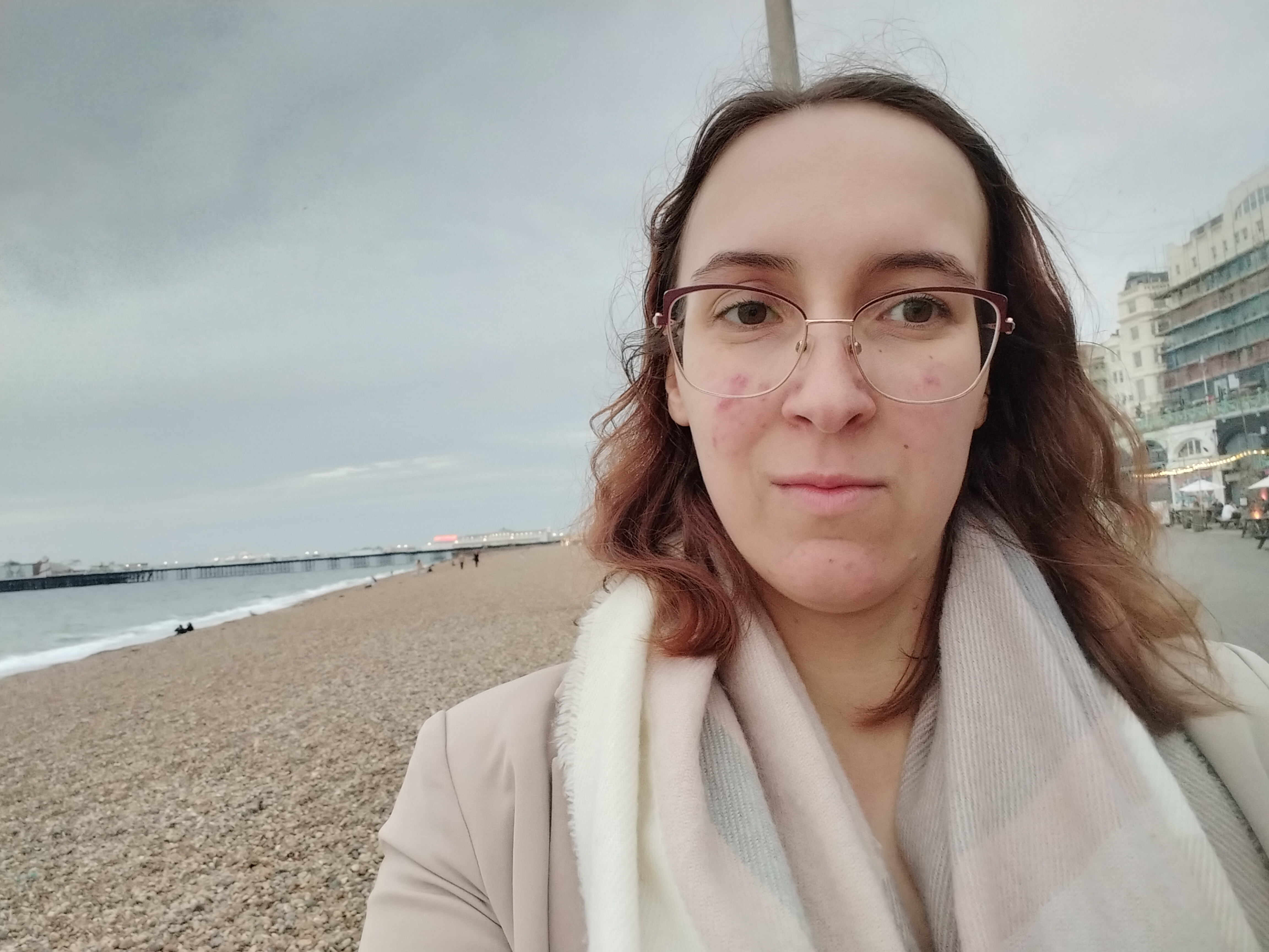 Demi Van Malcot walking on the beach in Brighton, on the way to the post MotaCon 2025 meet-up