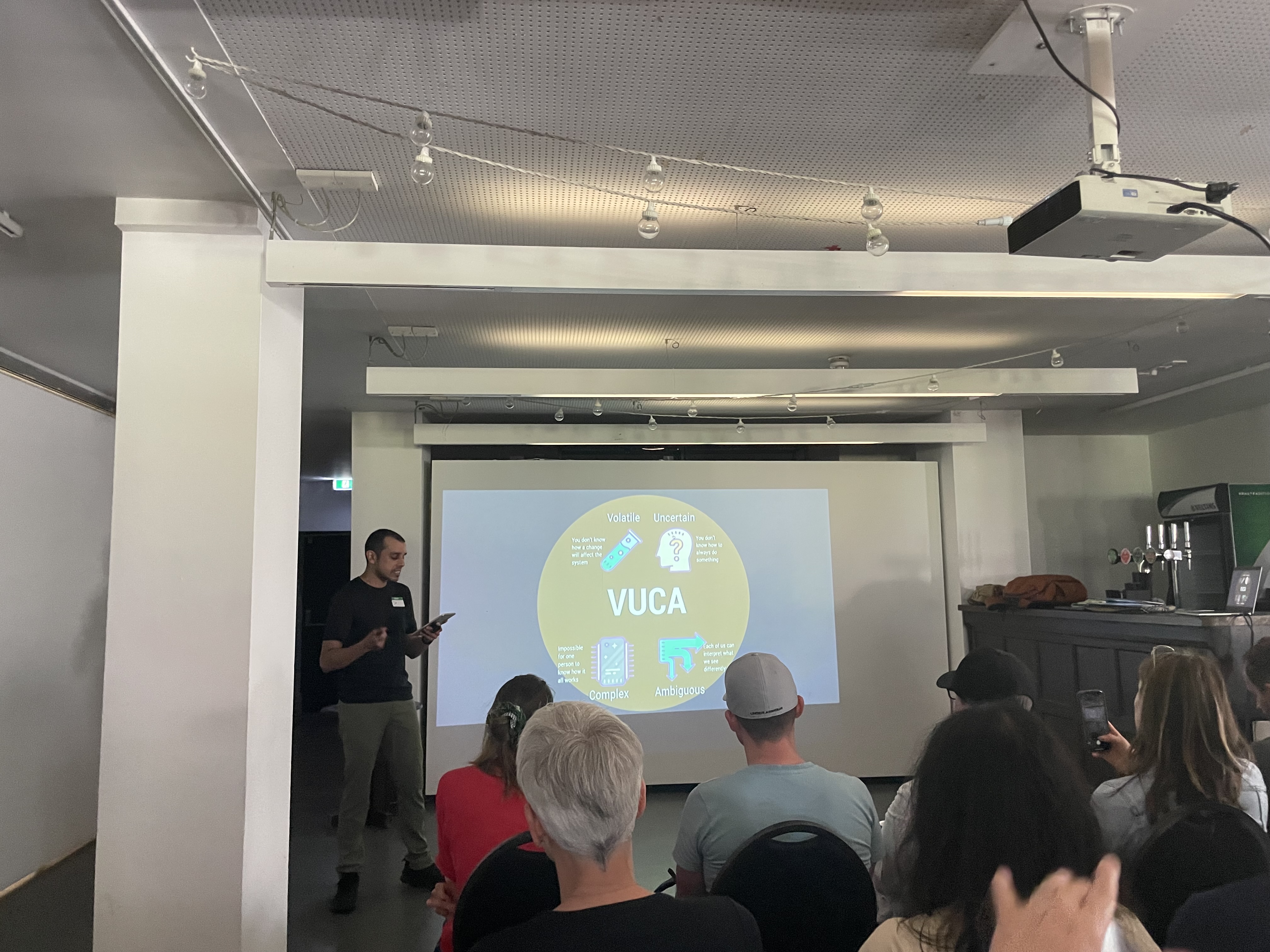 Jit on stage with a slide on VUCA.