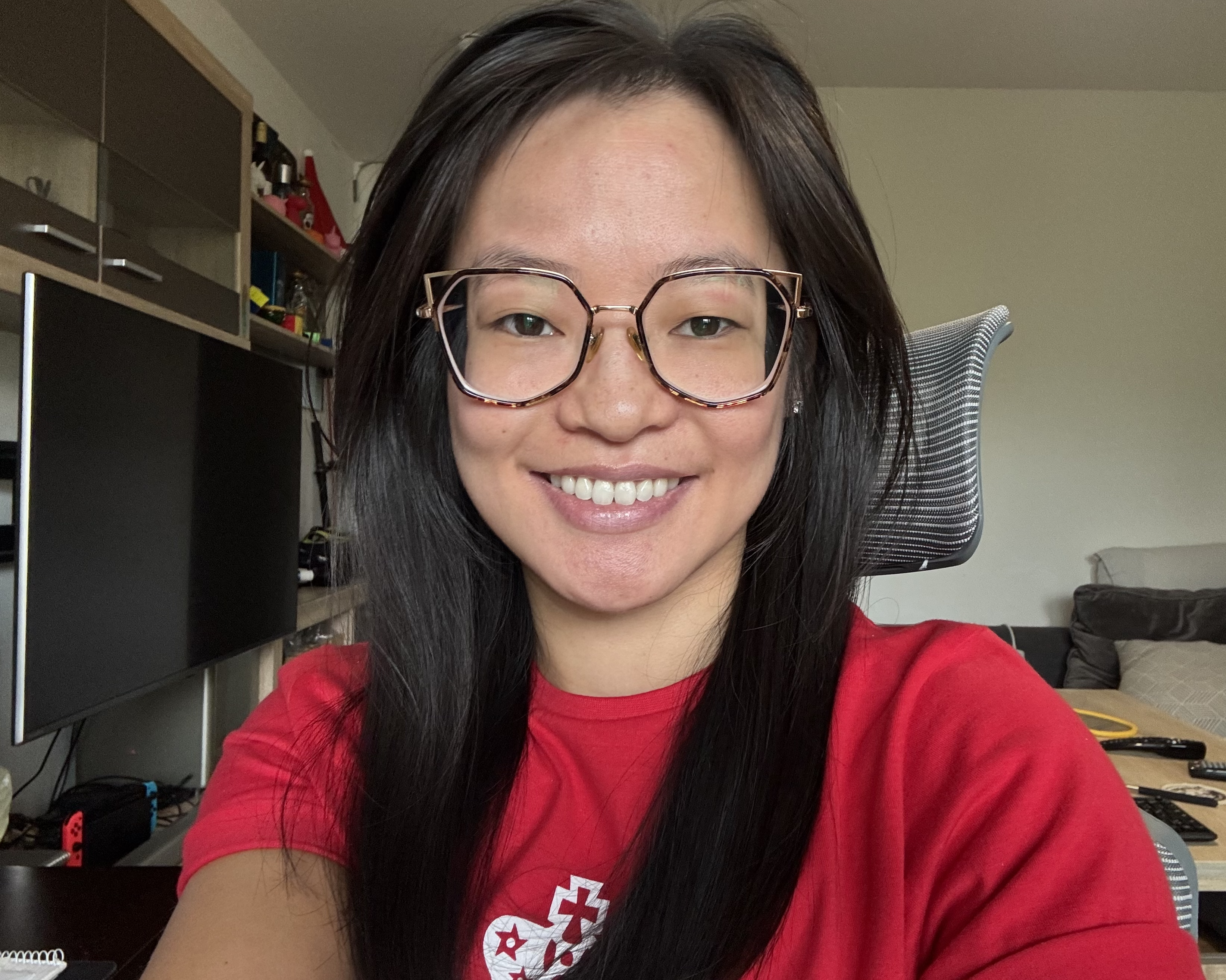 Selfie of Cassandra in a vintage, red, MoT t-shirt.
