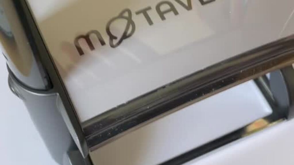 a short video of a big stamp in action. It stamps out the word MoTaverse.