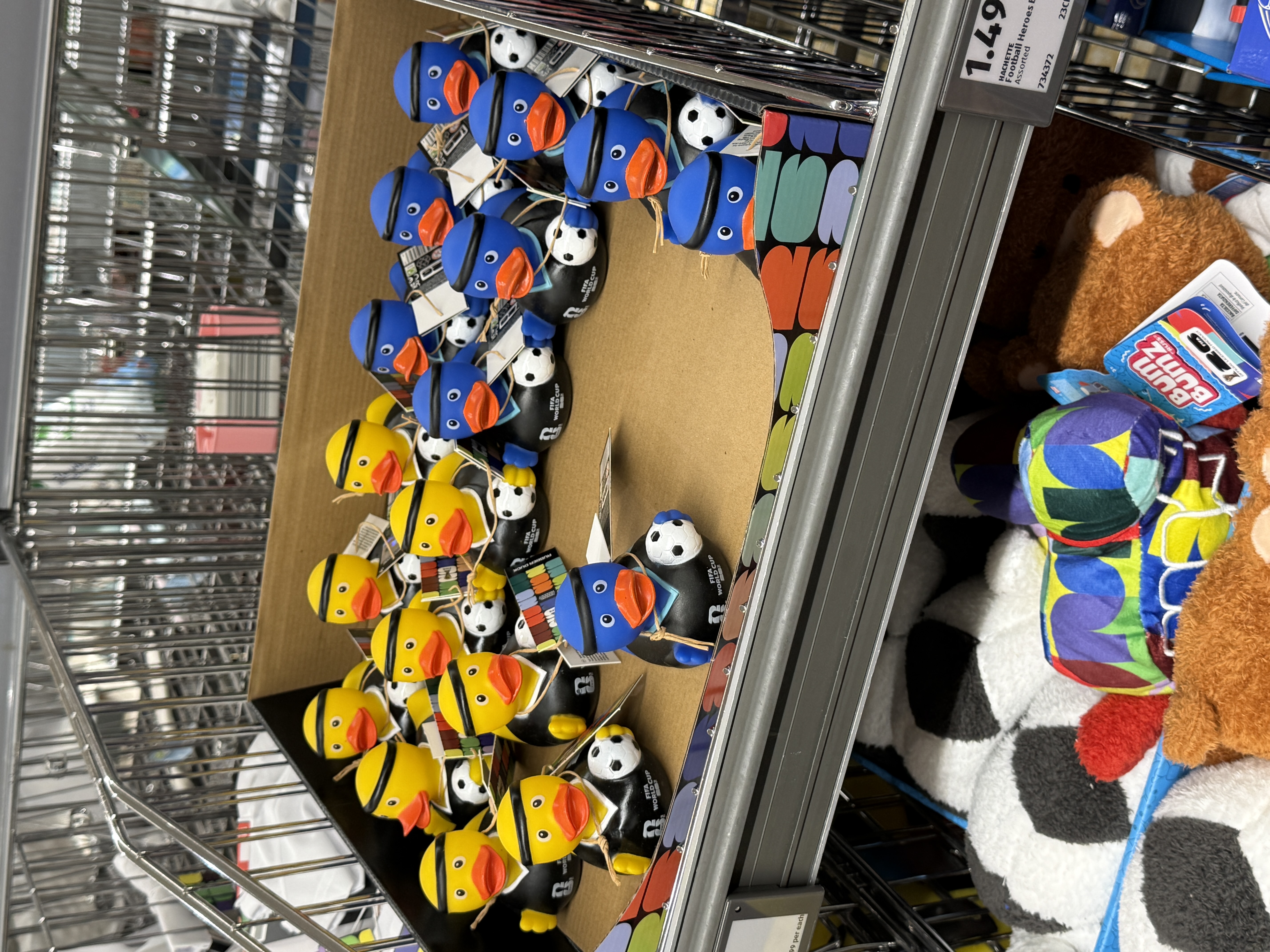Blue and yellow ducks holding a football and wearing a headband on a tray on a supermarket shelf image
