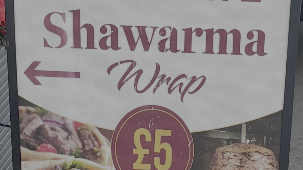 A sign which reads: "STOP HAVE Shawarma wrap £5' image