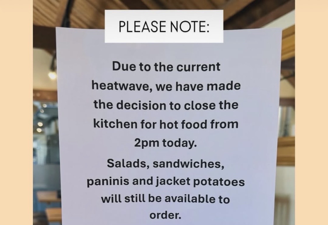 A sign that reads 

"Pleas note:
Due to the heatwave, we have made the decision to close the kitchen for hot food ... image