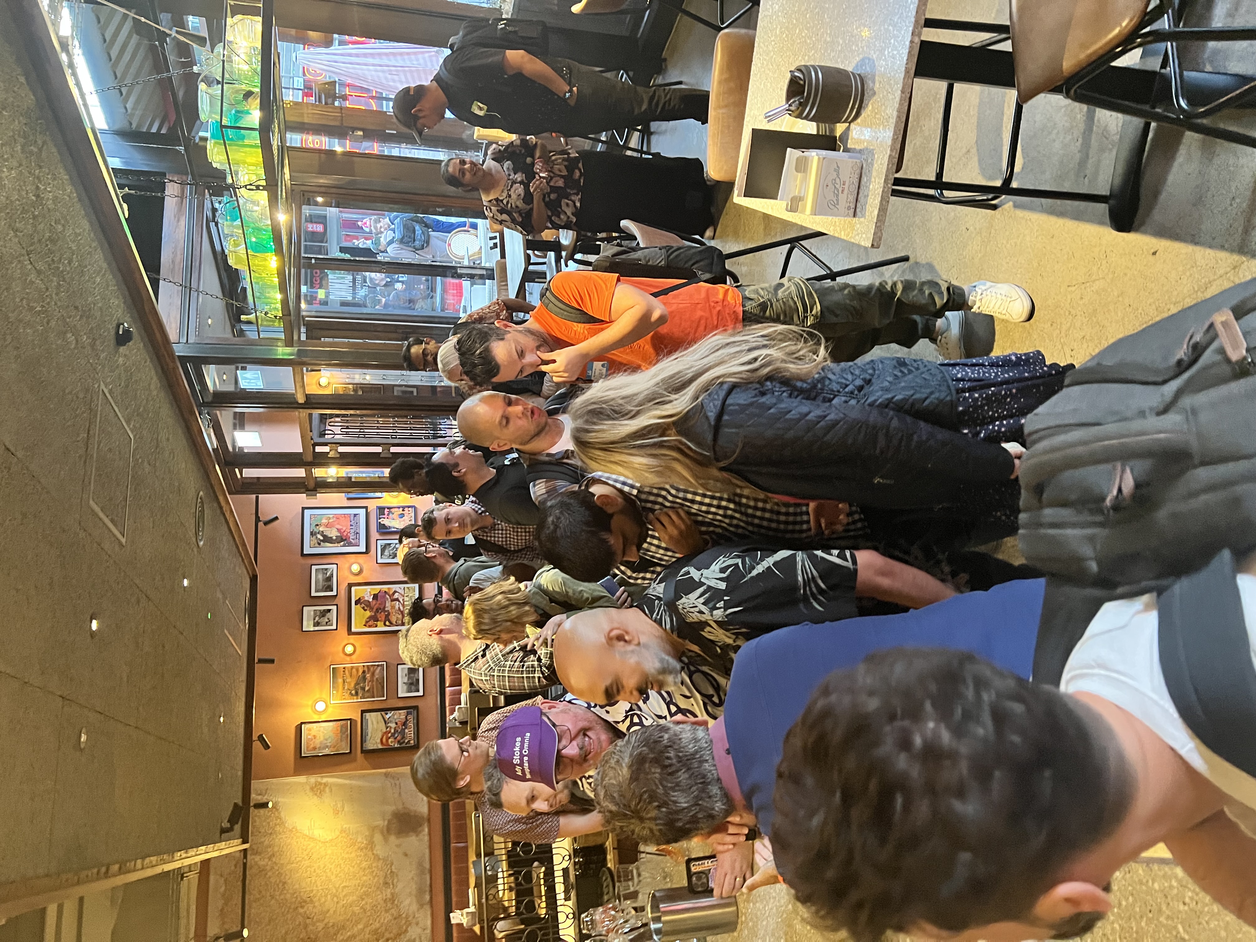 A large group of quality engineers in a bar London all wanting to get a drink. 