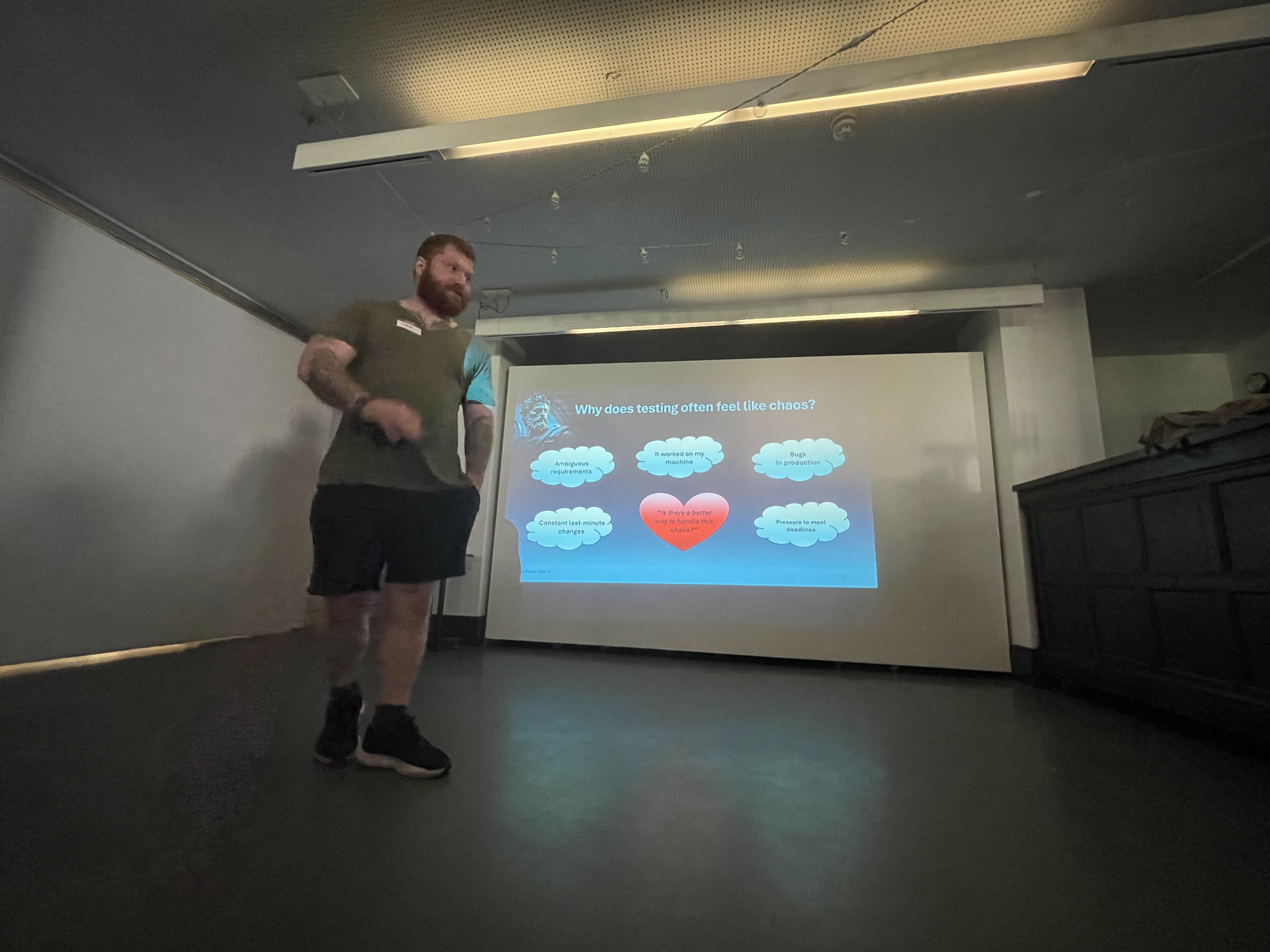 Stephen Platten looking strong and stoic, with slides behind him.