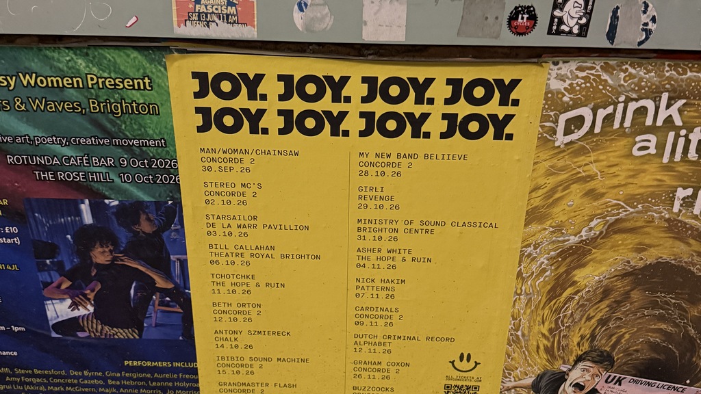 A poster with the word “joy” repeated several times.  image
