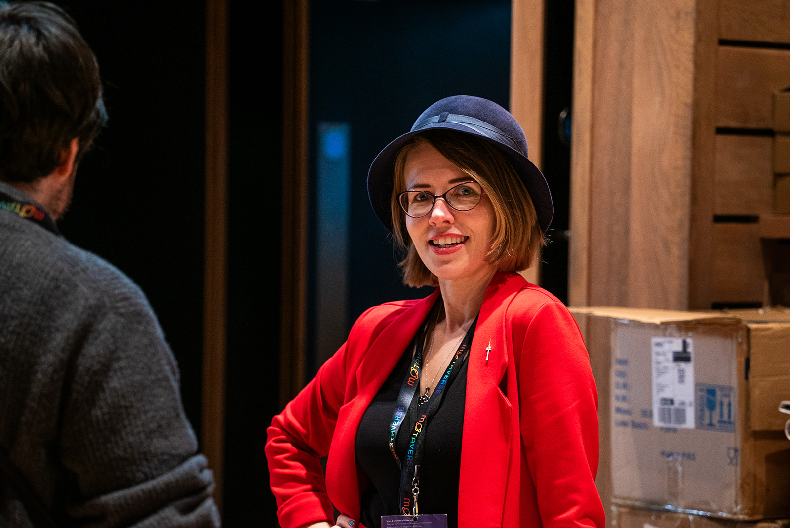 Christine Pinto dressed in red with a casual smile.