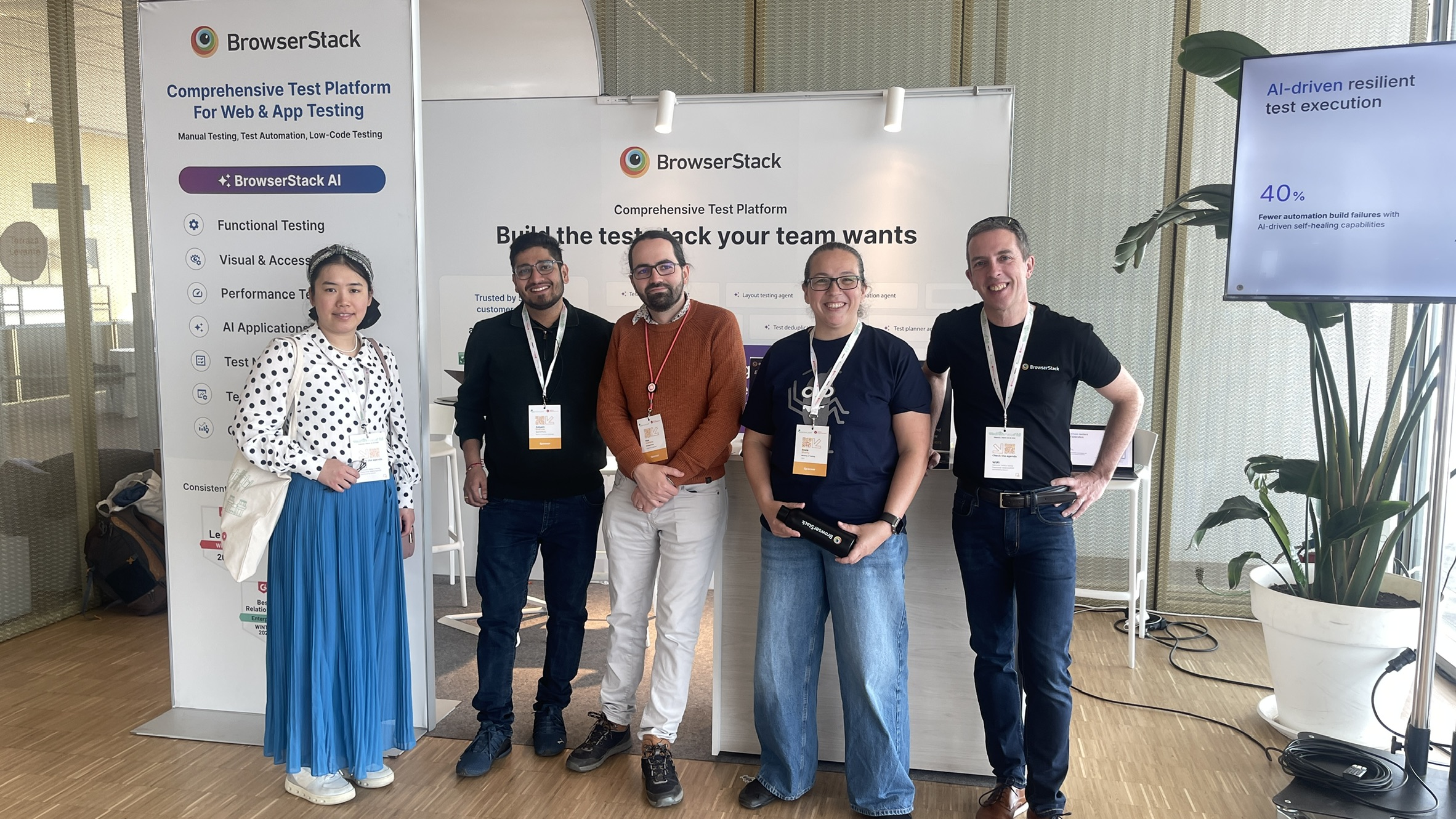 The BrowserStack crew and Rosie from MoT gathered at their stand, mid-sponsor loop, all smiles and looking conference-ready. Branding, banners, and Bug energy everywhere.