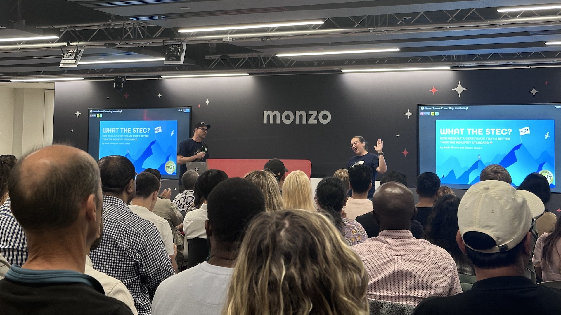Rosie and Simon presenting to an audience.