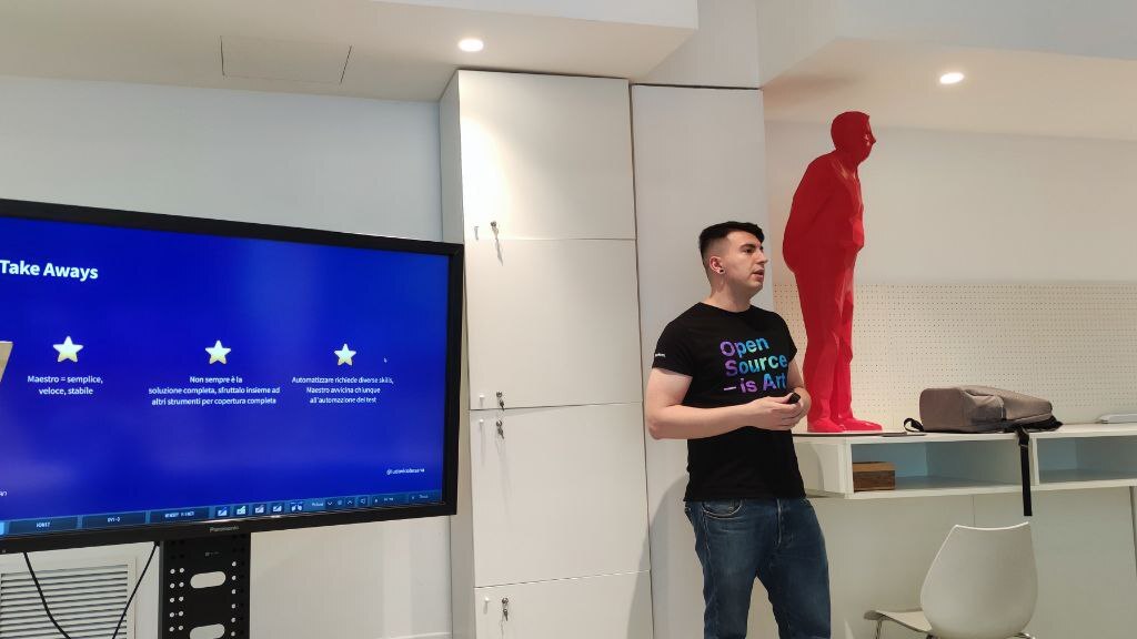 A small crowd gathered at a cozy meetup space in Milan, watching a live demo on mobile test automation. Smiles, laptops, and snacks. The first Ministry of Testing Milan event in full swing.