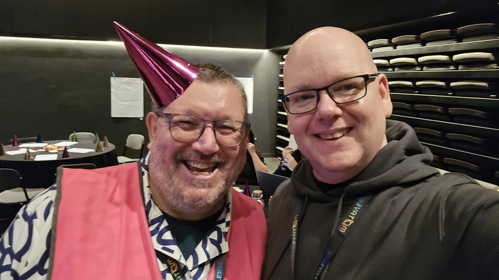 Selfie of myself (Richard Hinton) and Ady Stokes, with Ady wearing a pink hi Viz jacket and pink party hat image
